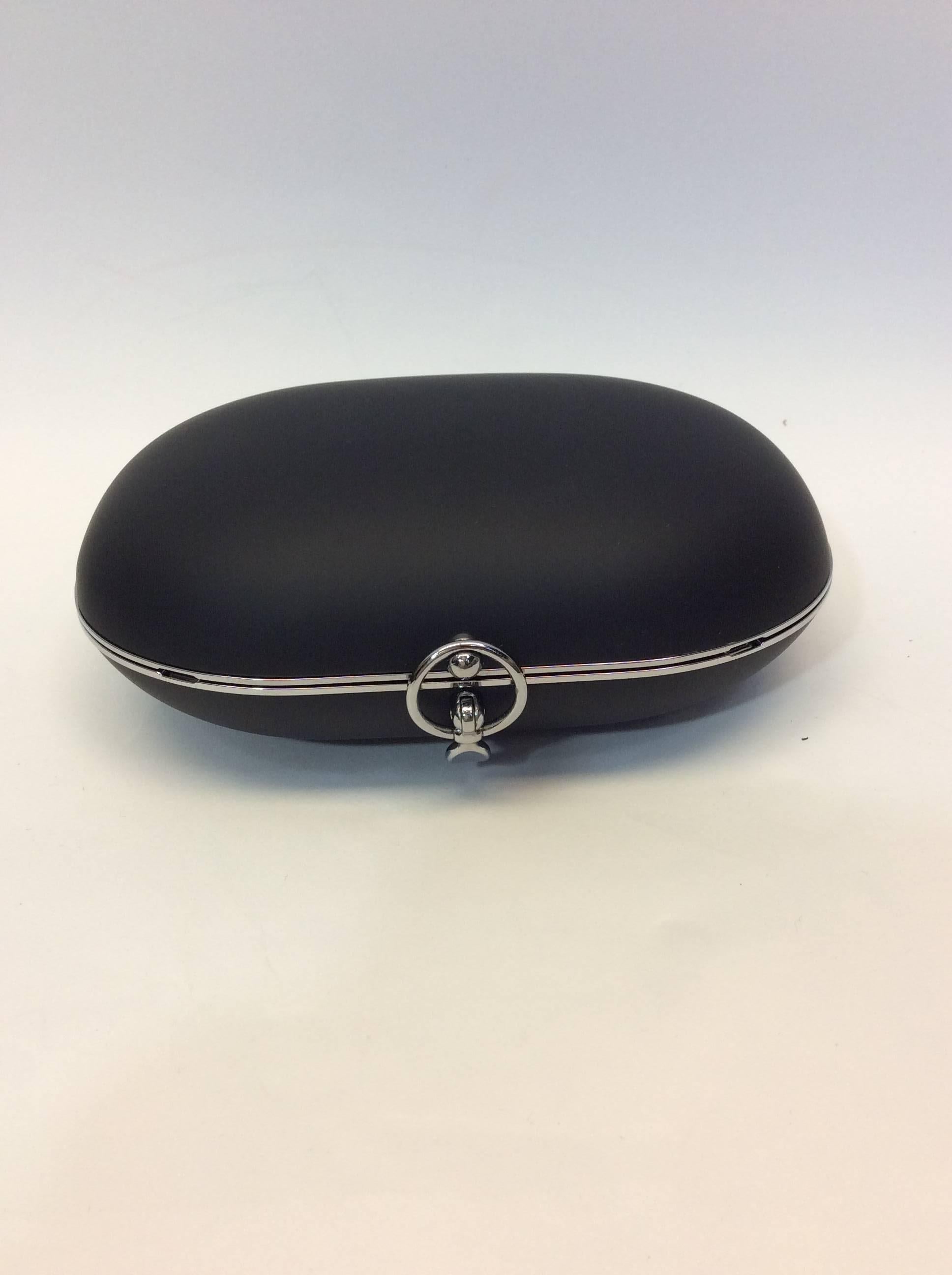 Black Egg Clutch
5 inches tall, 7.5 inches wide, 1.5 inches deep
Includes 30 inch removable shoulder strap
Clasp closure on top of bag
Features two open interior pockets
Aerospace aluminum and Italian lambskin