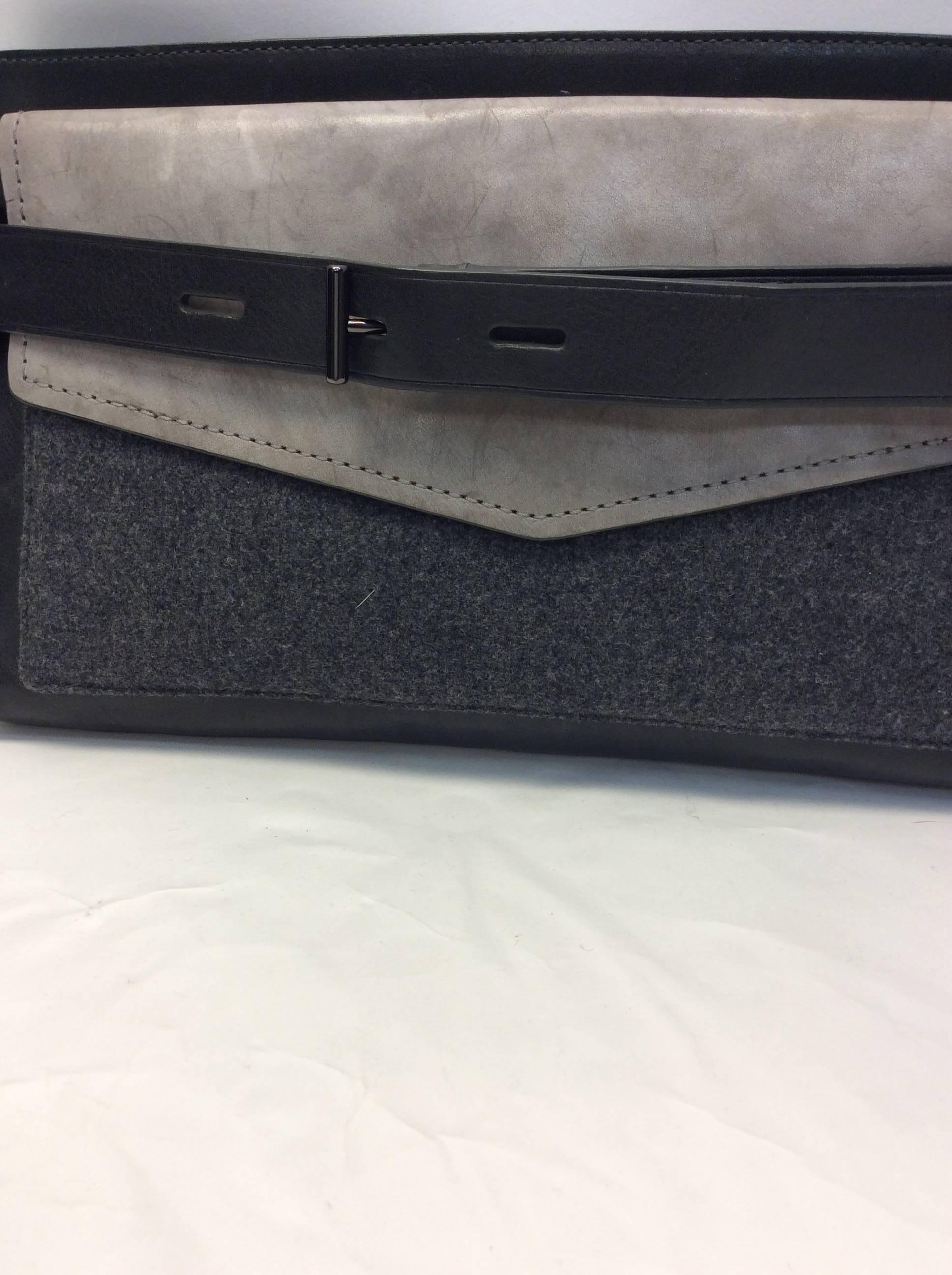 Reed Krakoff Slate Gray Buckle Clutch
Leather clutch with felt pocket detail
Top zip closure
$285
Exterior buckle