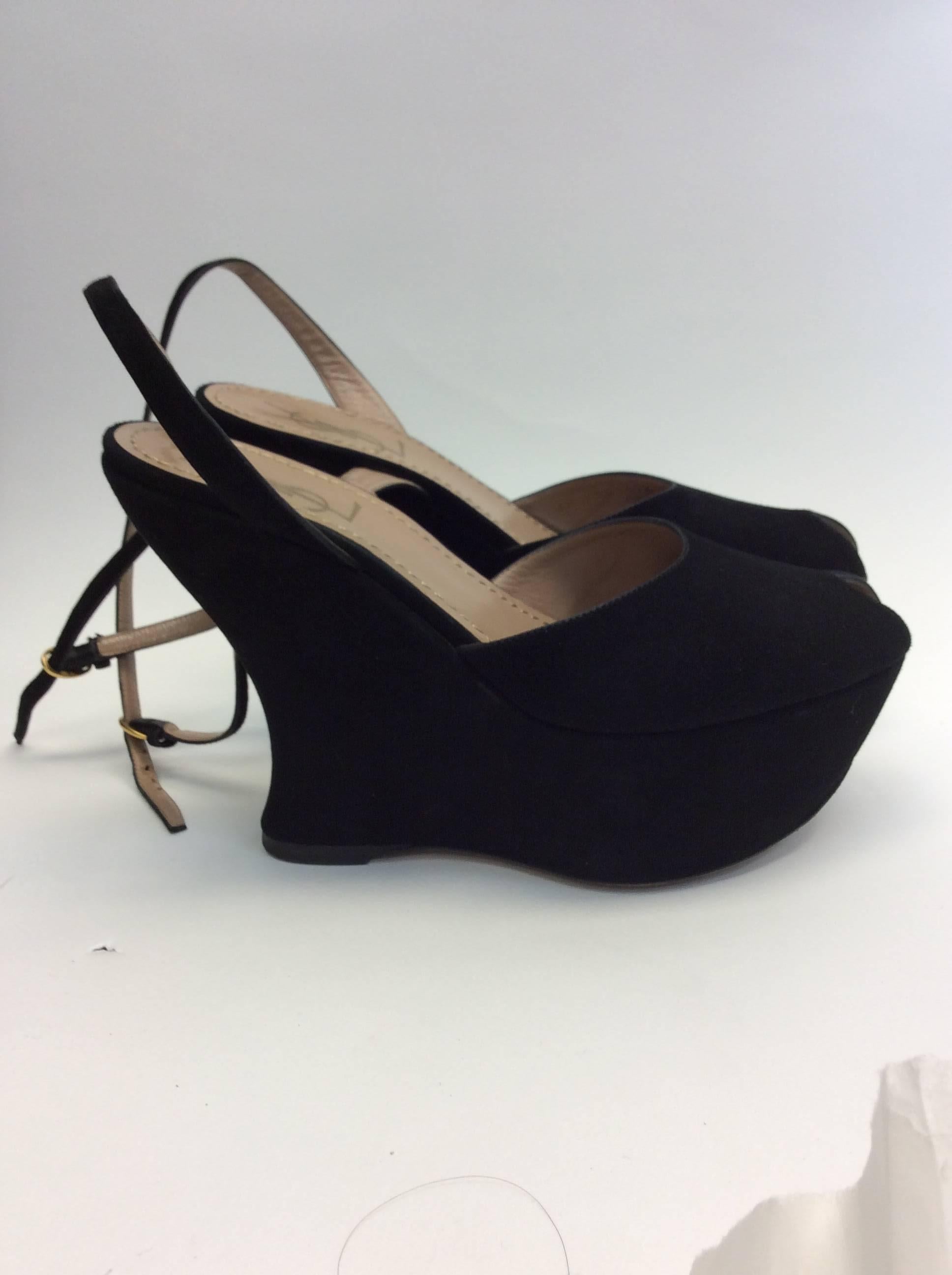 Yves Saint Laurent Suede Wedge
$299
Size 37
Made in Italy
5 inch heel with ankle strap and peep toe