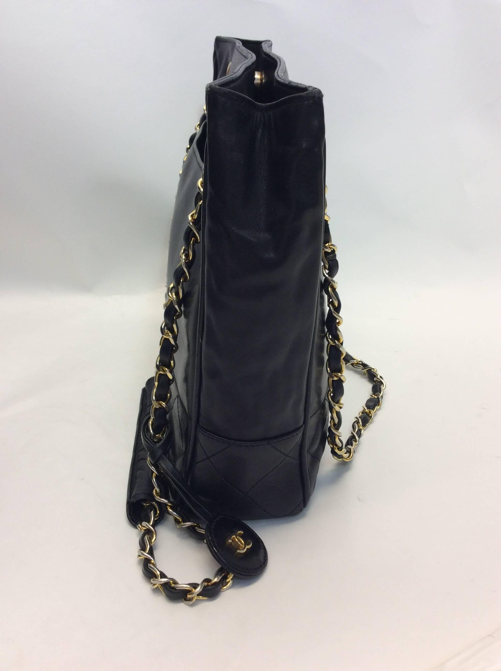Vintage Chanel Black Quilted Chain Shoulder Handbag
Made in Italy
Features quilted section
Exterior pouch section on backside of bag
Gold tone chain with leather 
Interior zipper pocket 
$1100