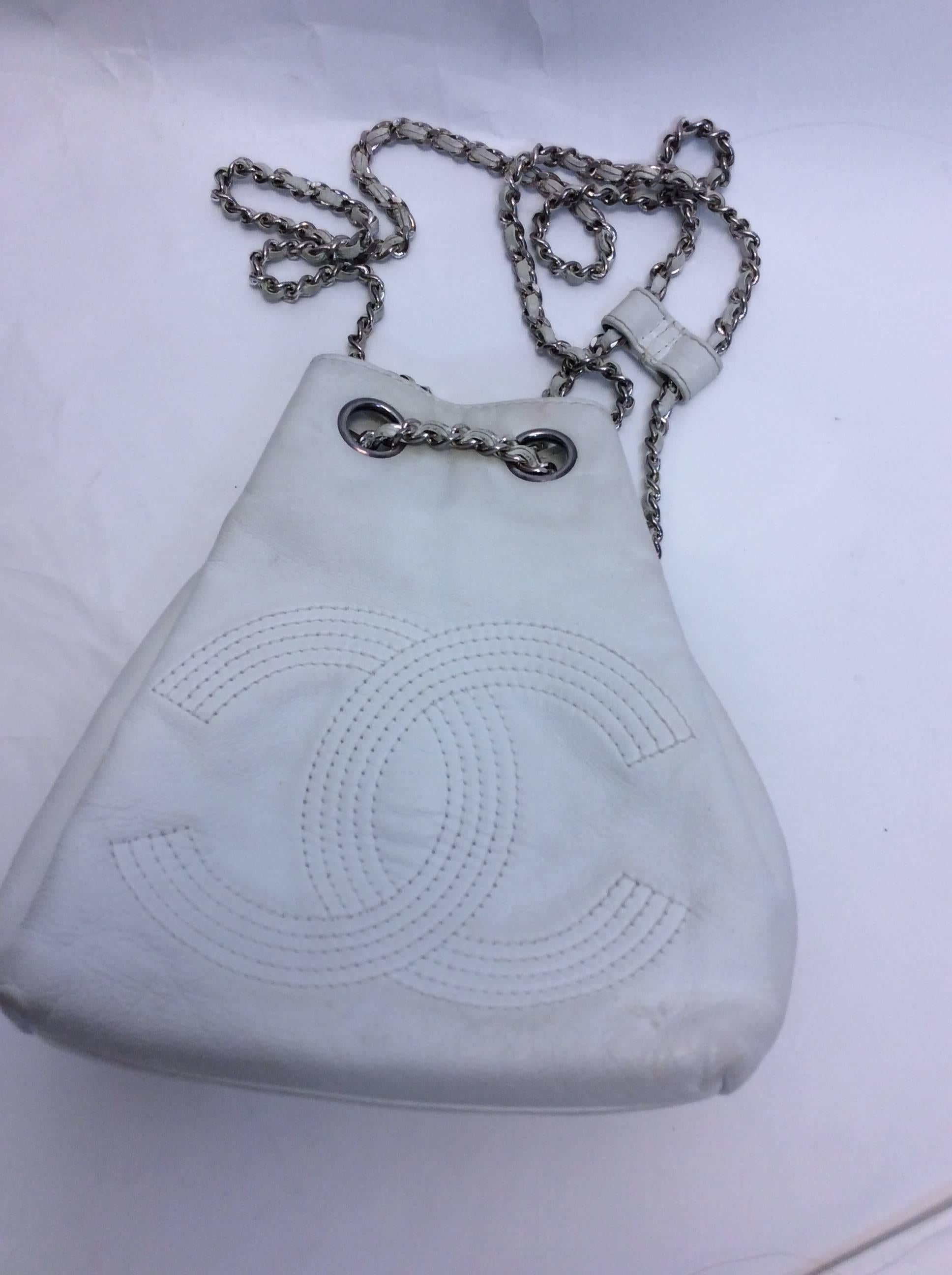 Chanel White Small Vintage Backpack
CC logo stitched in center of backpack
Silver chain backpack straps with leather center for adjustment 
*Condition is fair: Pen marks on inside and staining on exterior. Please reference photos
Comes with coin
