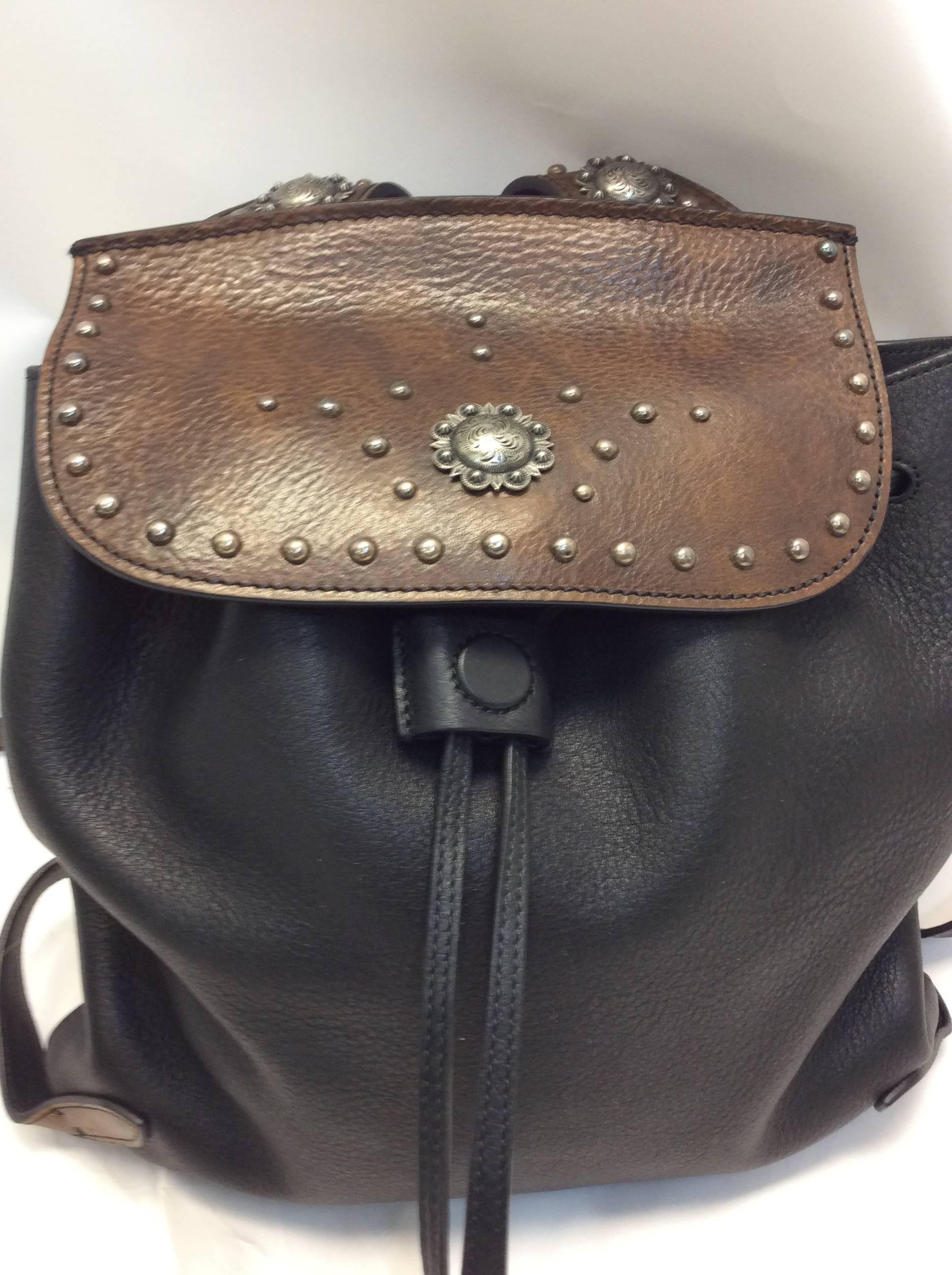 Ralph Lauren Two Tone Embellished Backpack
$350
Black and brown two tone coloring
100% leather
Silver hardware detailing 
Interior is fully lined 
Made in Italy