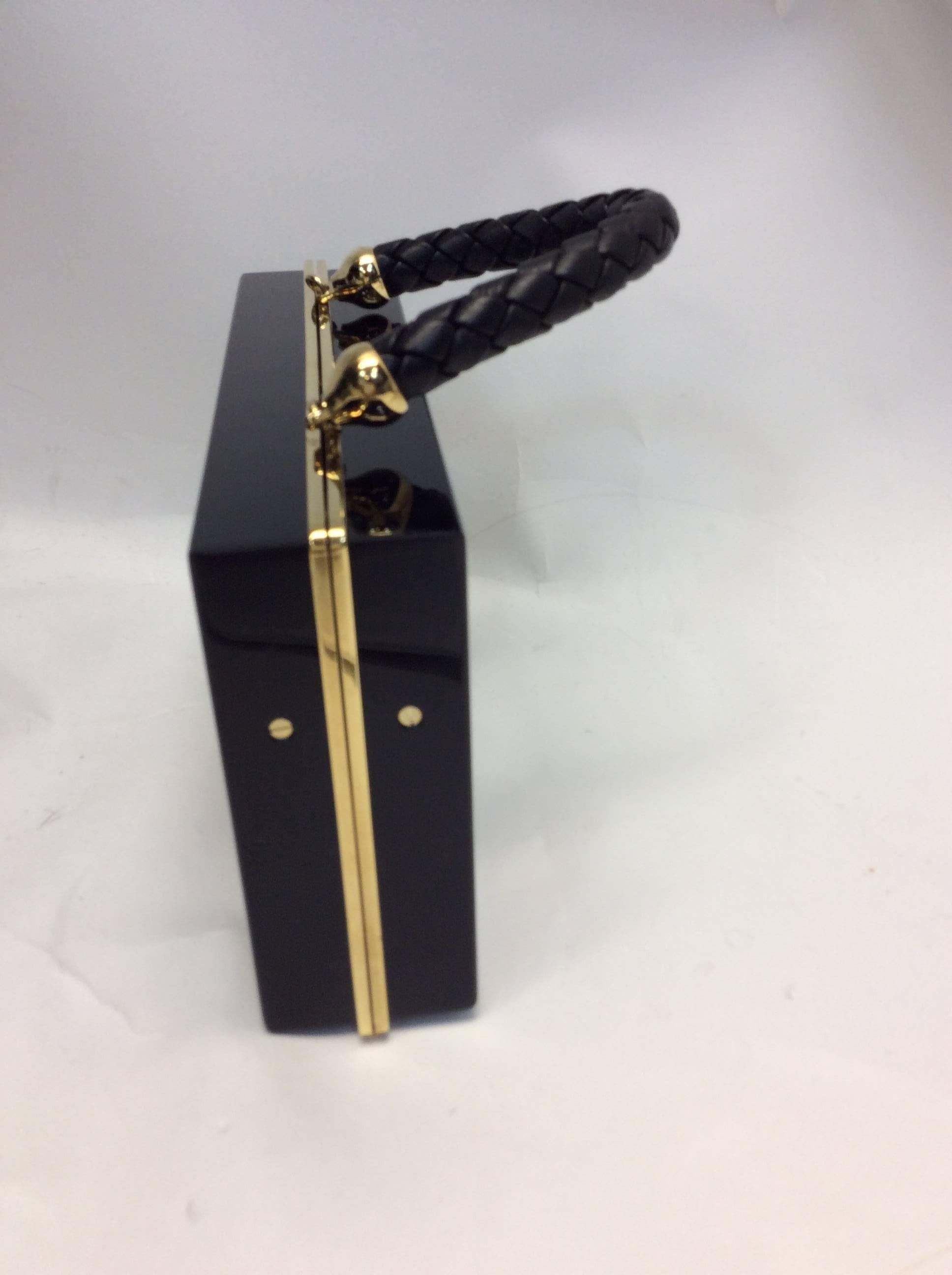 Charlotte Olympia Black Acrylic Box Clutch
Leather top handle 
Gold toned trim 
Key hole design on front 
Made in Italy
$399