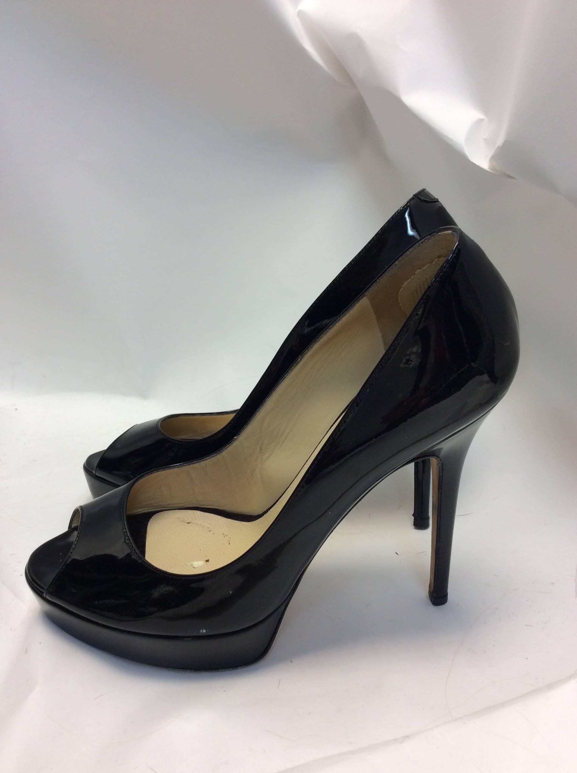 Jimmy Choo Black Patent Leather Platform Peep Toe Pumps
5 inch heel, 1 inch platform
$499
Size 39.5
Made in Italy