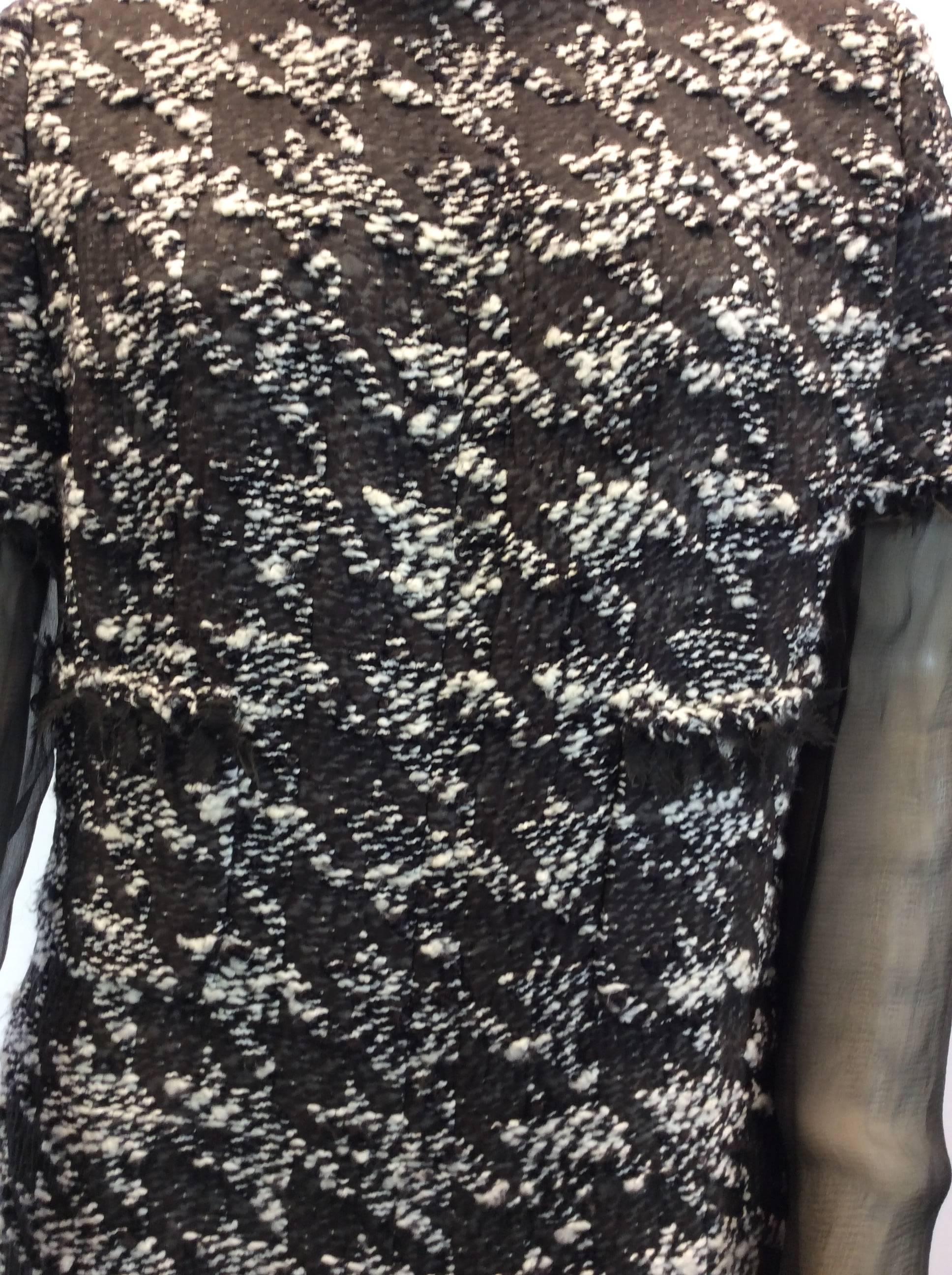 Chanel Tweed & Sheer Dress
Brown and white tweed print
Small pull on the back, please see photo
Black sheer detail on sleeves and skirt of dress
$1250

