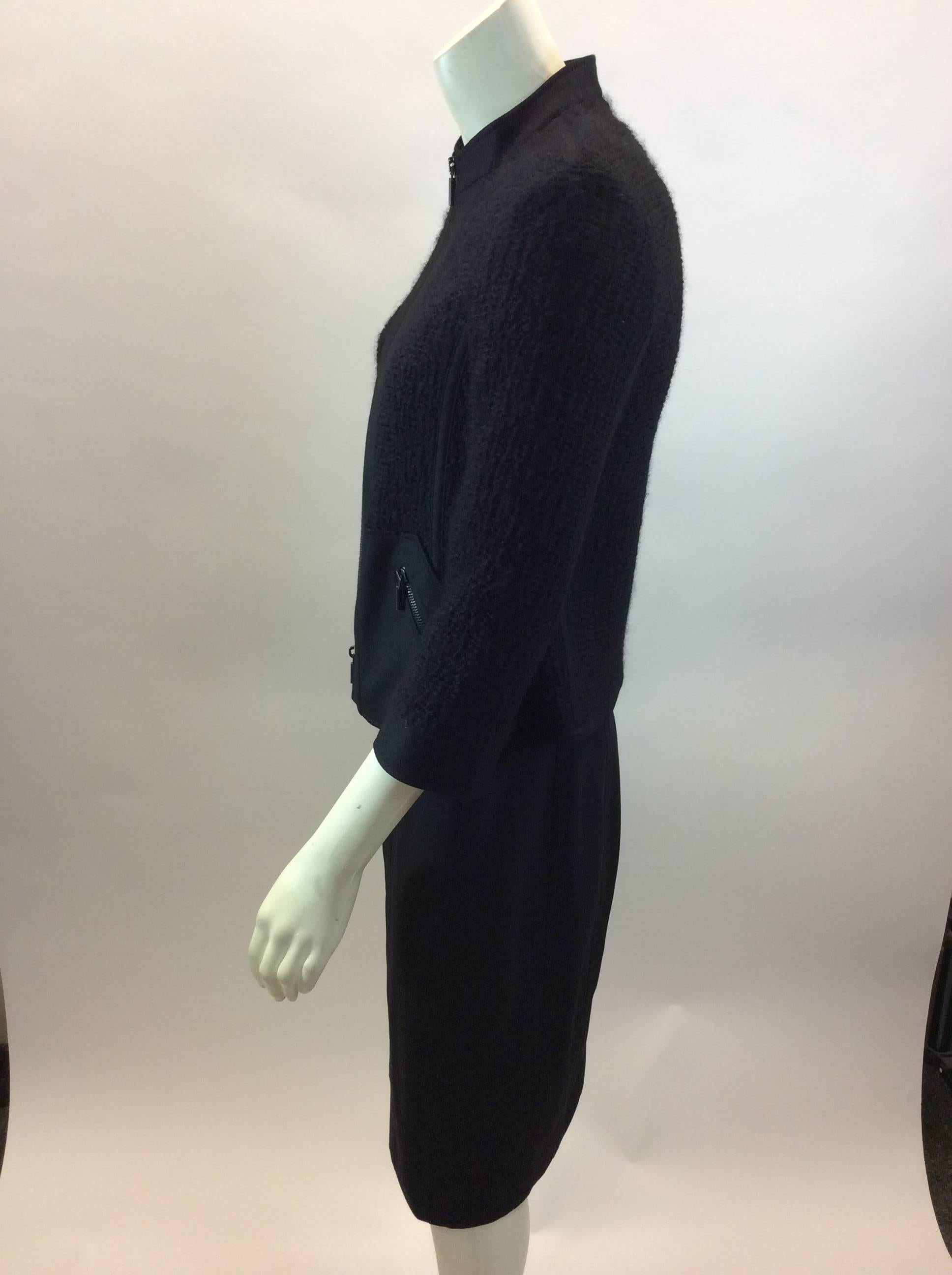 Akris Black Wool Two Piece Skirt Suit 
$199
Made in Switzerland
Skirt: Size 6
52% viscose, 46% Wool, 2% Nylon
Length 23