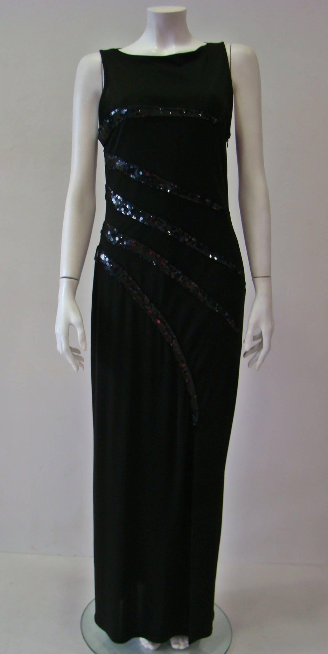 Dress To Impress With This Unique Loris Azzaro Evening Dress. A Sleeveless Unlined Dress With Concealed Zip Fastening At Side And An Oval Neck, Featuring An Eye-Catching Sequin Detail In Black And Front Sleam Split. 