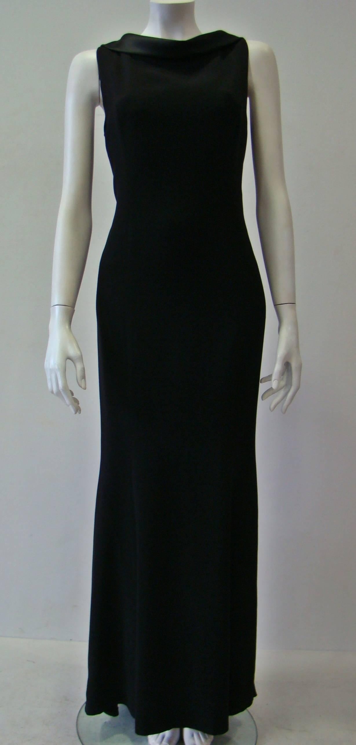 This Unique Angelo Mozzillo Dress Has A Bygone Elegance. A Very Impressive Design Featuring A Cowl Neck And A Striking Back With Straps That Wind From One Arm To The Other. It Has Full Lining And A Concealed Zip Fastening At Side And It Swoops Low