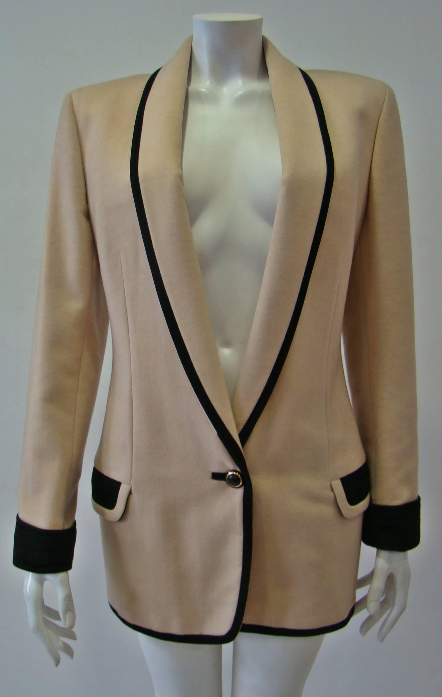 This Unique Piece From Gianni Versace Has Been Tailored To A Mid Length And Is Elevated With Striking Black Trimming In The Sleeves, Pockets And Around The Jacket Which Create An Elegant Look When It Is On. Spun From Warm Wool With Velvety Touch,