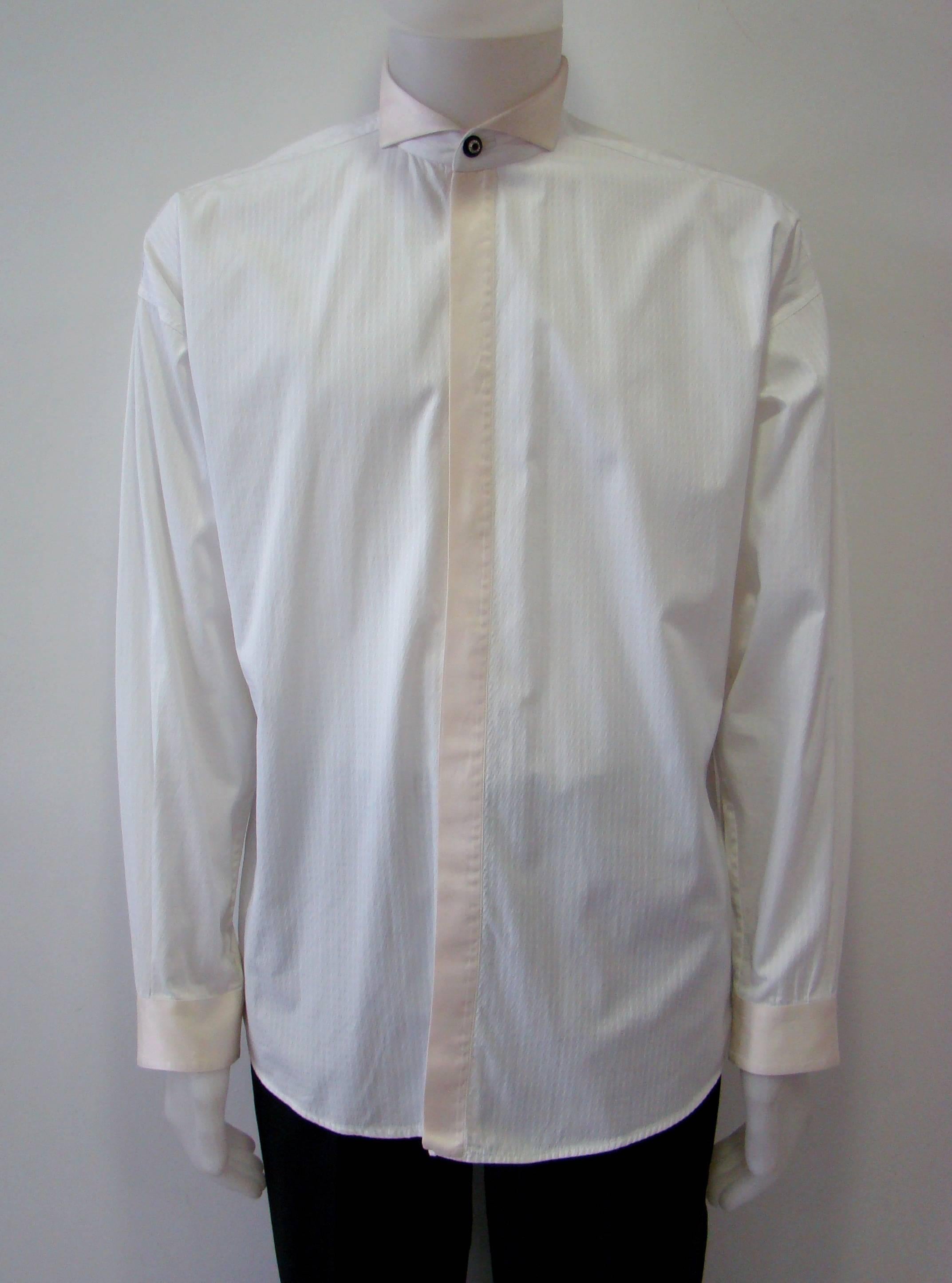 A Modernly Elegant White Shirt With A Traditional Tuxedo Collar Featuring A Front Bib, Covered Placket And Concealed Front Buttoning. An Amazing Combination Of Cotton And Silk Fabric, Detailed With Creme Satin Sheen Fabric At Collar And Cuffs. This