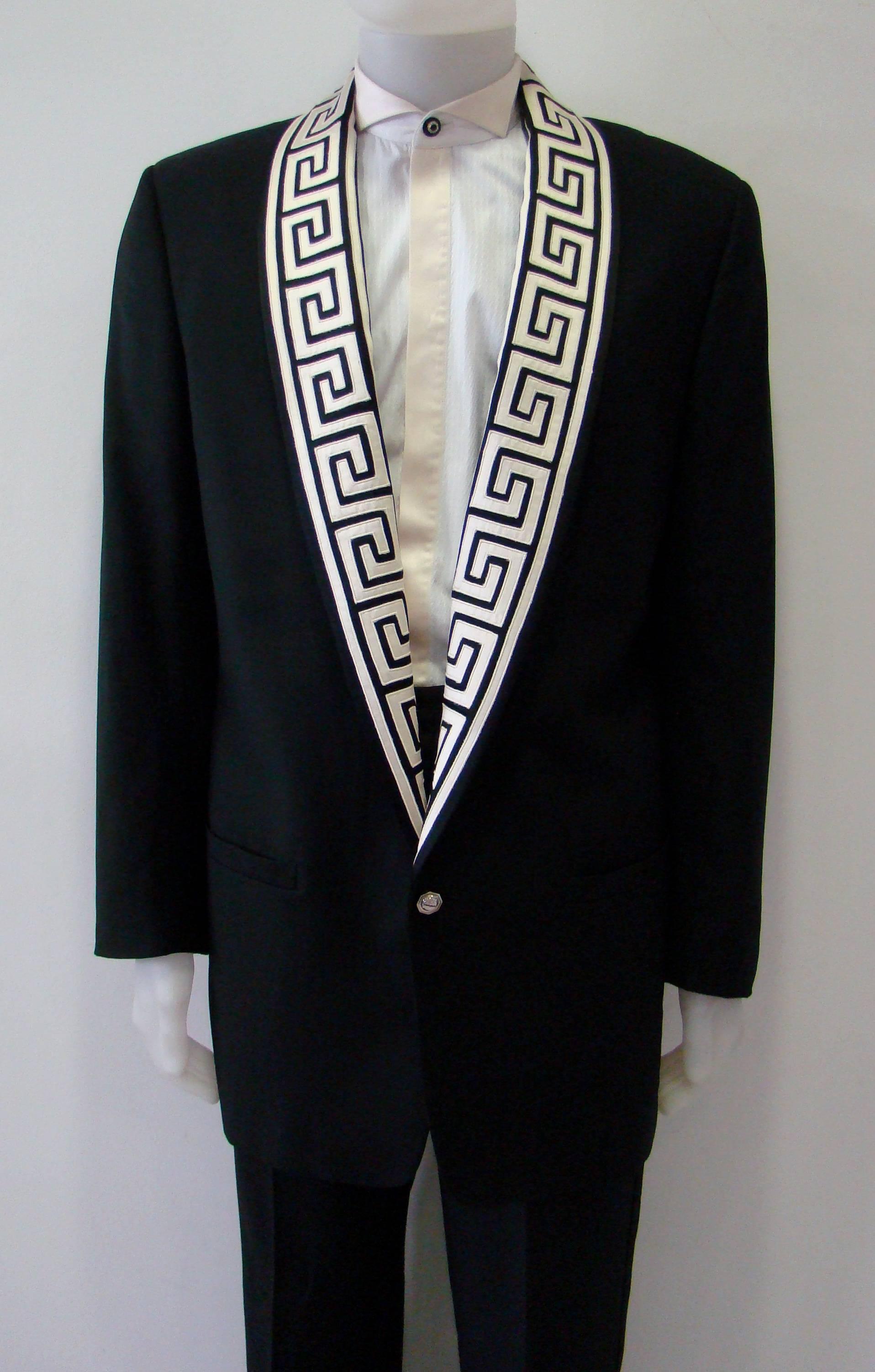 Museum Quality Gianni Versace Greca Detail Jacket. Expertly Crafted From Soft Virgin Wool This Piece Is Tailored Into Single Breasted Jacket Featuring Two Front Welt Pockets, Two Unfunctional Buttons At Cuffs, And An Eye Catching Shawl Lapel With