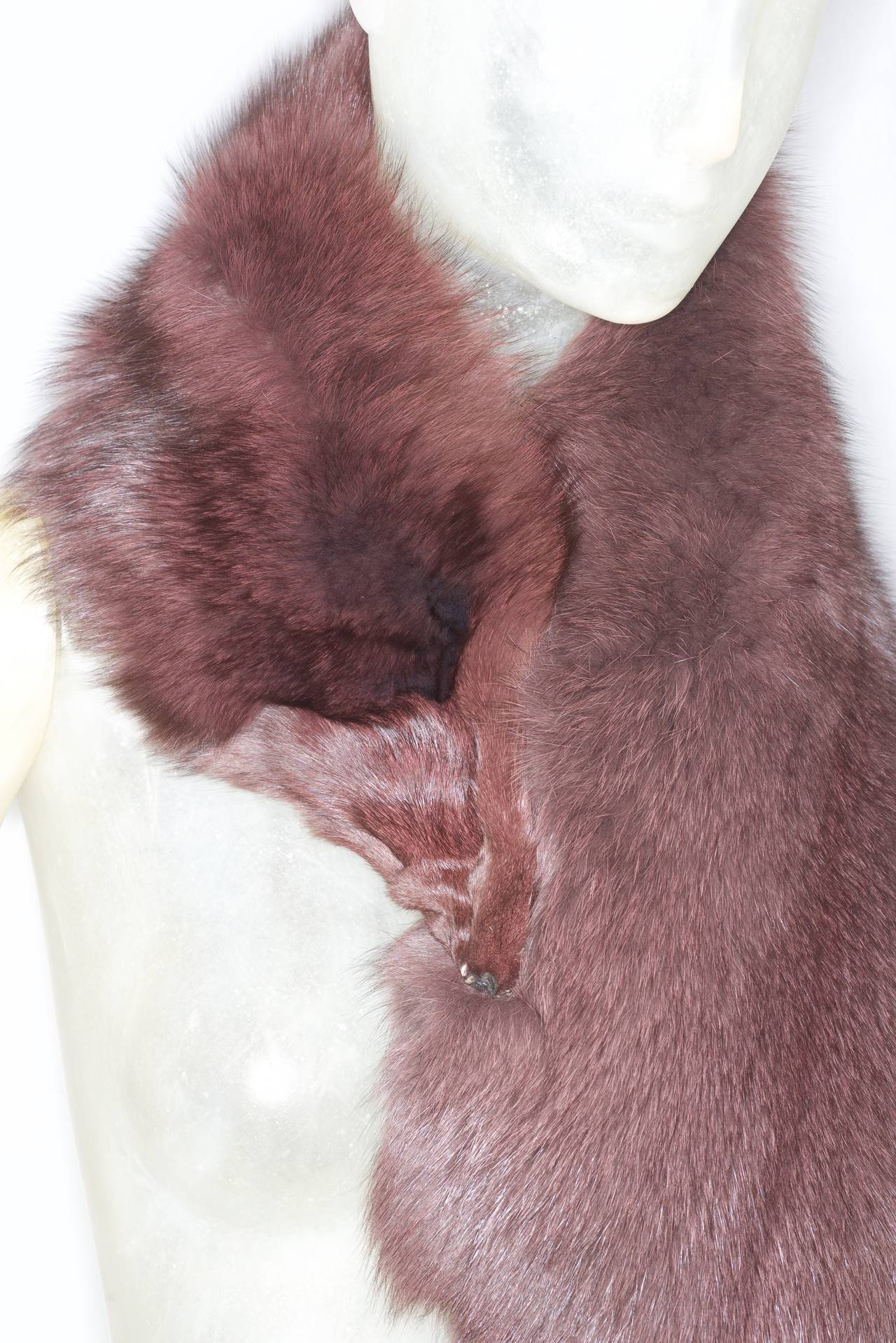 A whimsical plum colored fox fur collar/stole. Wraps around shoulders. Clip closure.