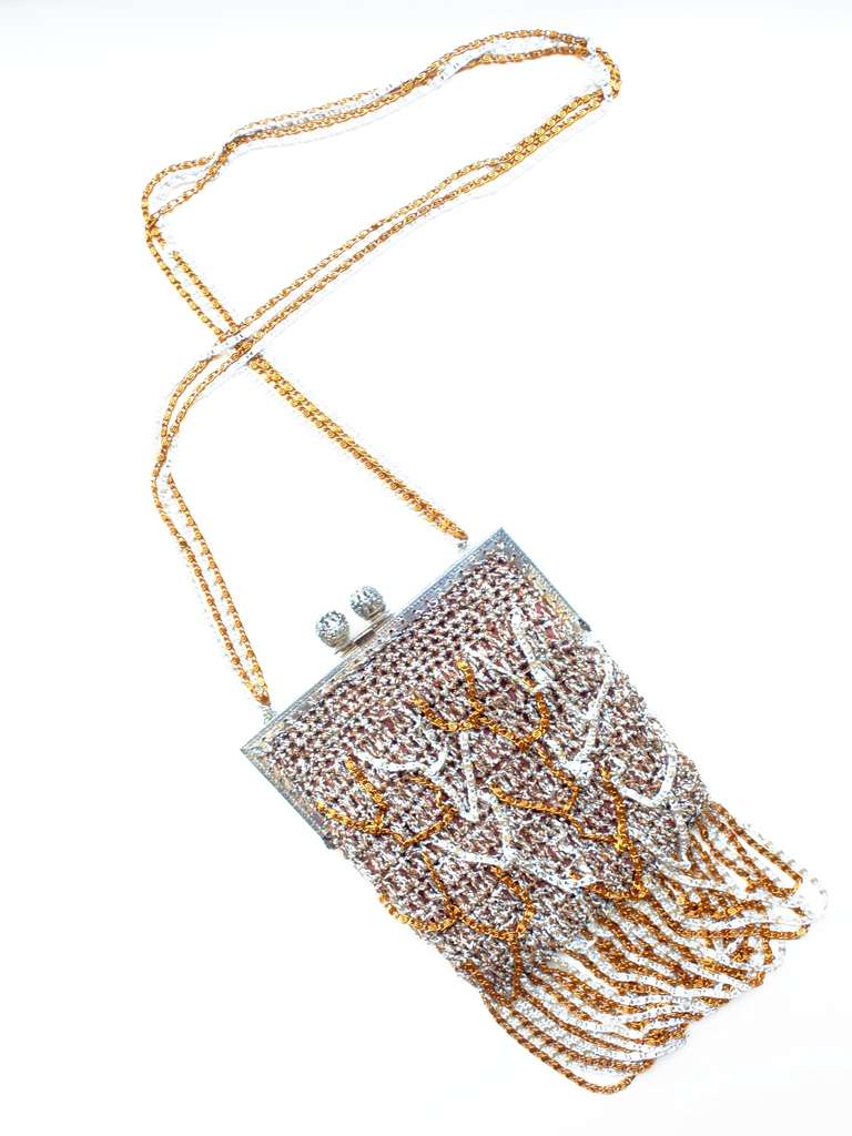 A glossy disco Loris Azzaro silver and gold lurex crochet bag with silver and gold chains and chain strap.  Bag is lined and labeled Loris Azzaro.