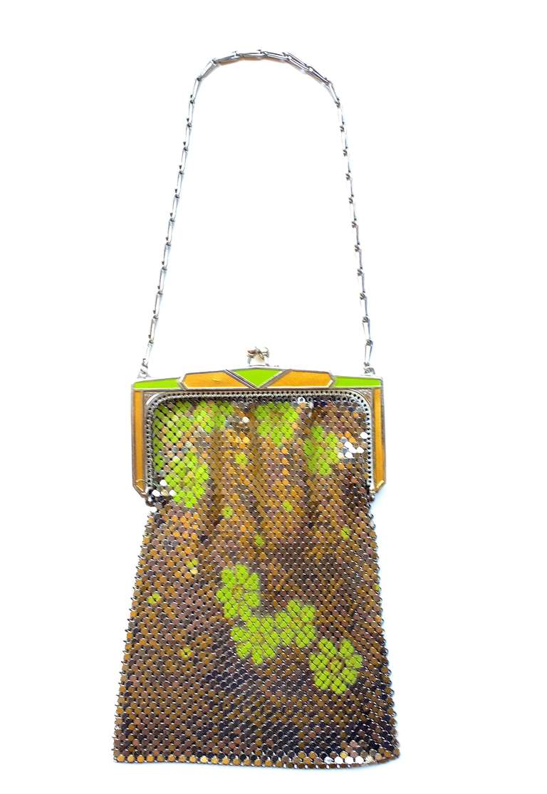 A sweet and slightly psychedelic Whiting and Davis metal mesh bag in sliver with lime colored flowers.  Signed Whiting and Davis on the interior metal frame.