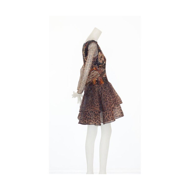 A fine and beautiful Valentino haute couture dress with a densely embroidered bodice with a Chinese motif.  Sleeves and skirt are of a leopard print organza.  A truly exceptional piece!

Will fit a contemporary size 4