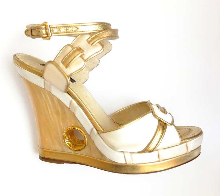 These cream silk and gold leather wedge sandals are from one of my favorite of Marc Jacobs for Louis Vuitton collections, Spring 2004.  The wedge heel is pearlized with a gold metal hole.  Glamorous and comfortable, the sandal is a wonderful and