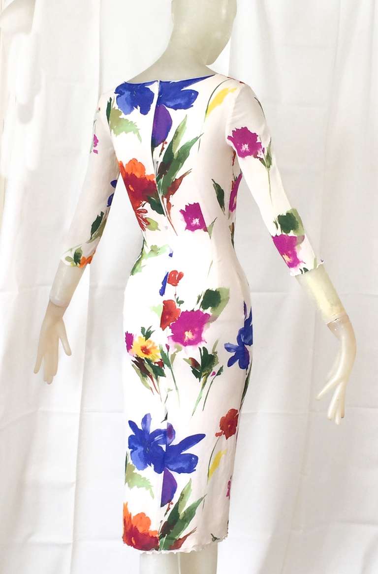 A very sexy dress from Dolce & Gabbana in a stretch floral silk with painterly flowers strewn across a cream background.  Dress has a typical corset like detail over the bust and is amazing!

Size 38.  Will fit a size 2/4