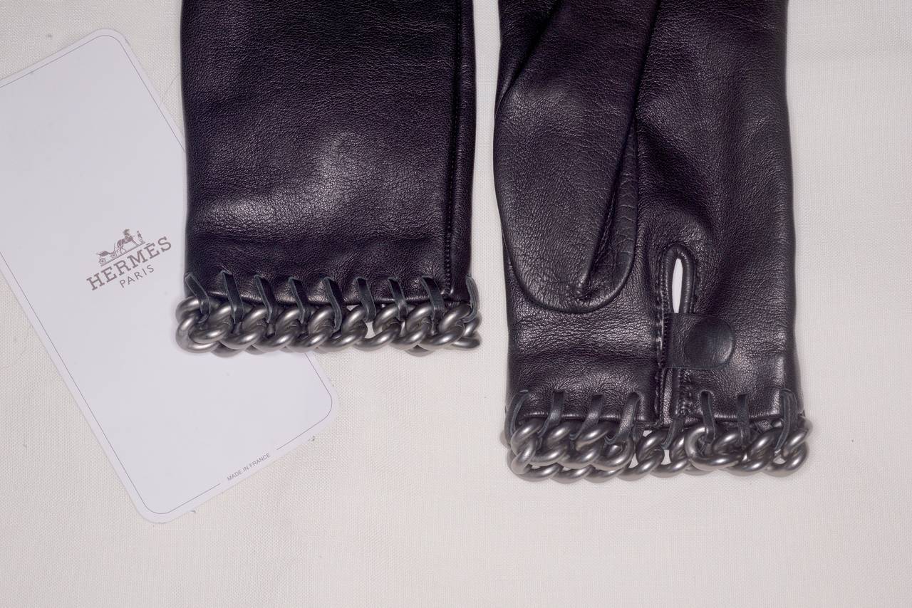A gorgeous pair of Hermes supple lambskin gloves with a rock and roll palladium plated metal chain detail.  Size 6 1/2.  Unworn.