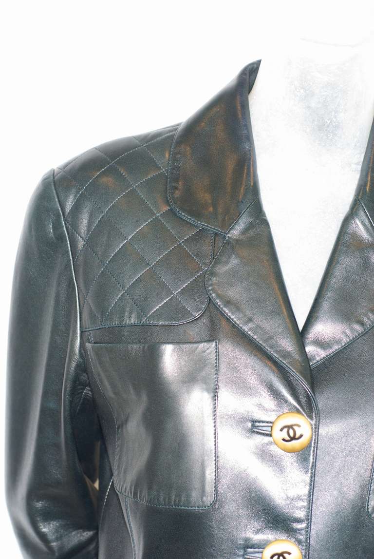 A rare vintage black leather (very supple) jacket by Karl Lagerfeld for Chanel.  Jacket has gold tone CC logo buttons and quilted leather detailing at the shoulders.  Excellent condition.

Bust: 36