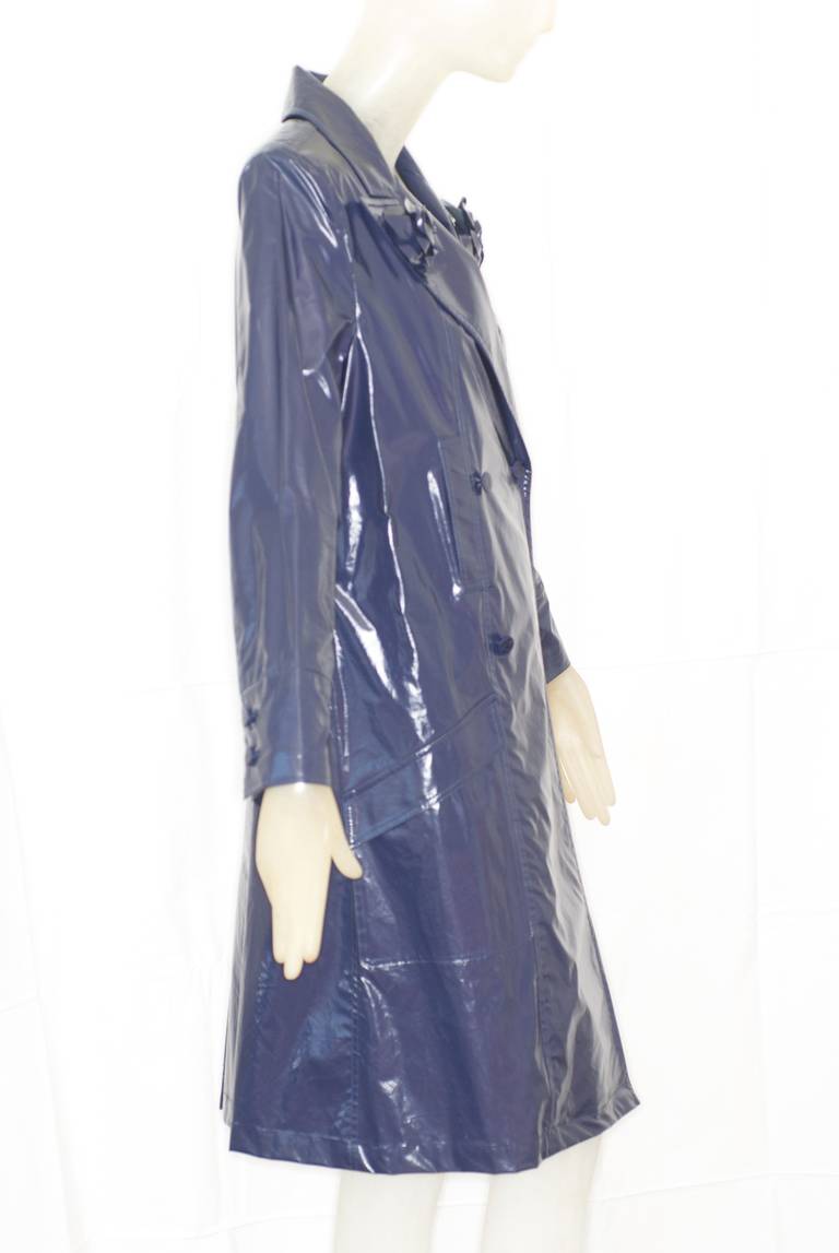 A Chanel raincoat in blue with camellias.  2003 collection.  Size 40.  Excellent condition.