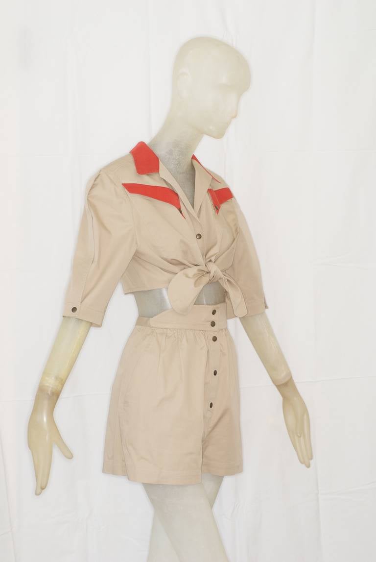 A super chic Thierry Mugler cropped top and shorts ensemble.  

Details:
Top is cropped, ties in the front and has snap front closure.  
Shorts have snap front closure.  
Waist on shorts is higher in the front.  
Soft fit.
Khaki colored