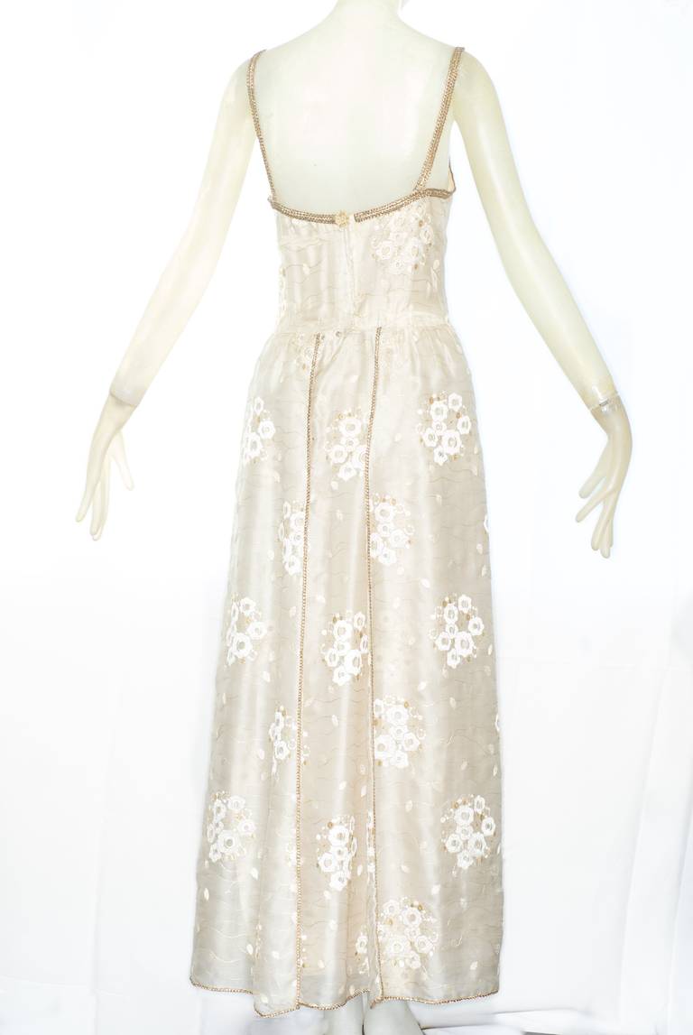 1972 Chanel haute couture dress.  Exit 75.  Runway piece. Chanel mid 1970s haute couture silk organza gown with short sleeved jacket. Swiss eyelet mountain pieris flower embroidery by LESAGE. Gold thread soutache braid trim. Lined in silk crepe de