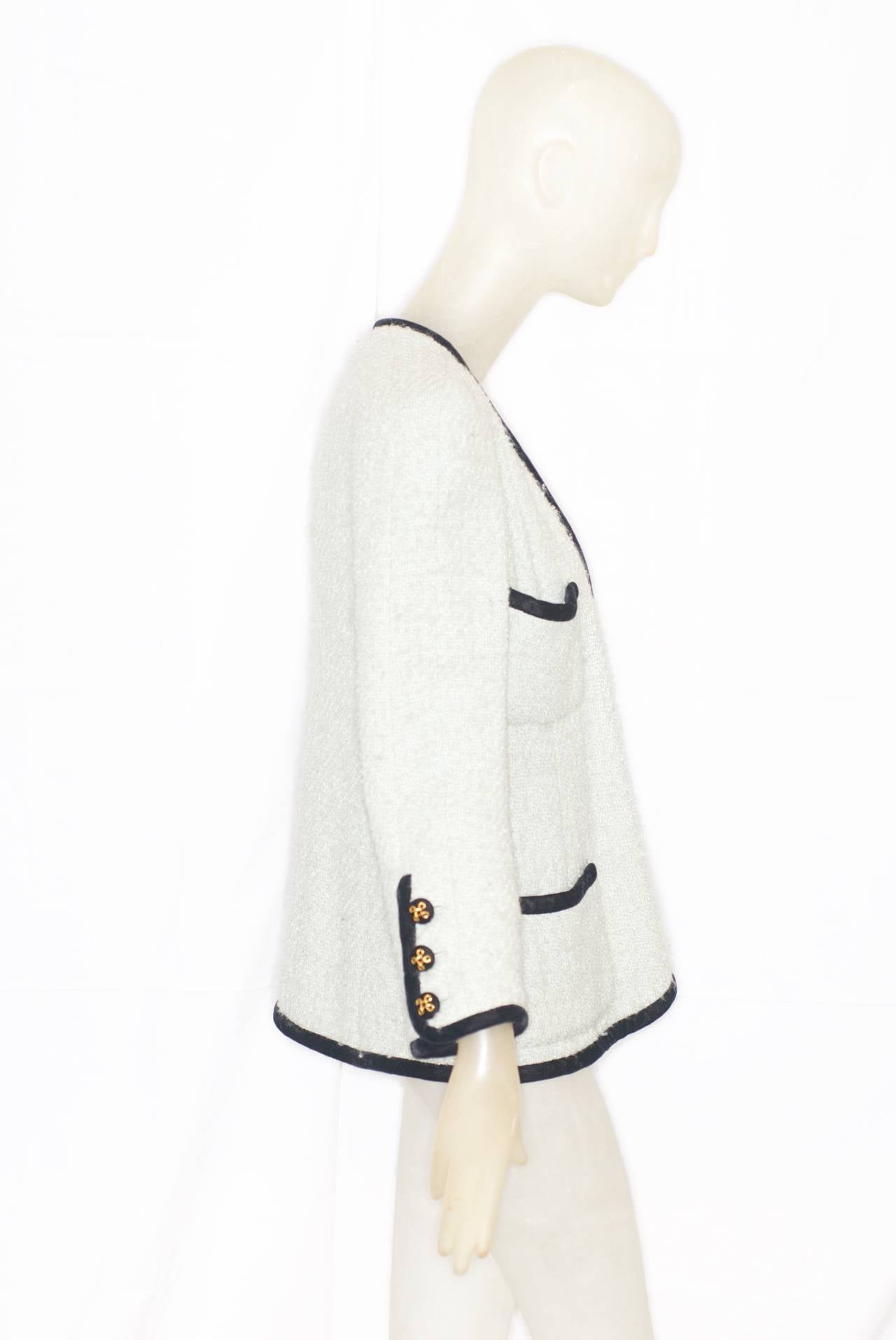 A Chanel haute couture pale mint colored jacket with black velvet trim from the early 1990s.