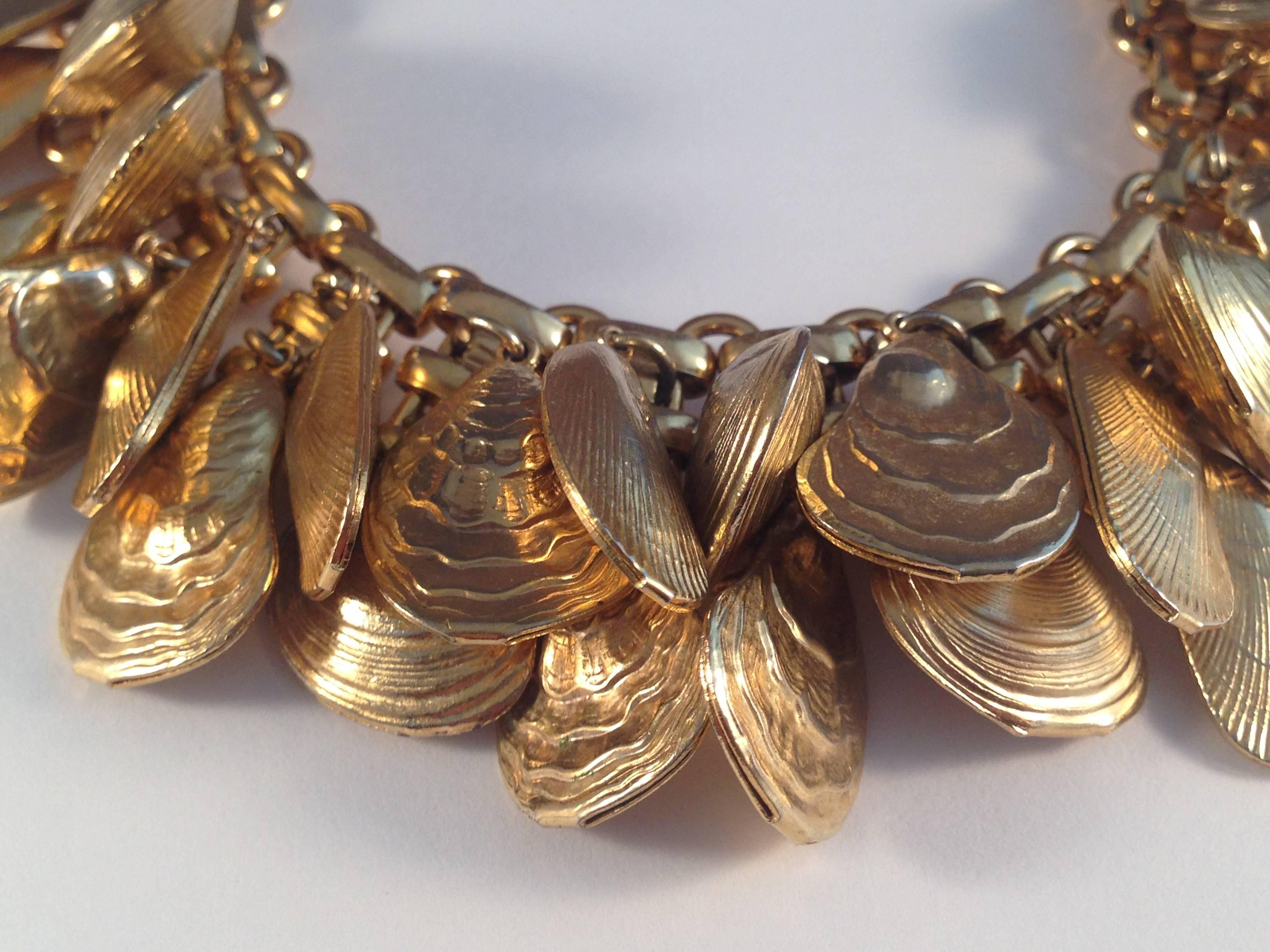 This vintage gold tone Napier bracelet features 30 seashell charms - including clam, oyster and mussel shells. This is a very desirable bracelet among collectors and it is rare to find one with all 30 shells intact. It features a 7 1/2
