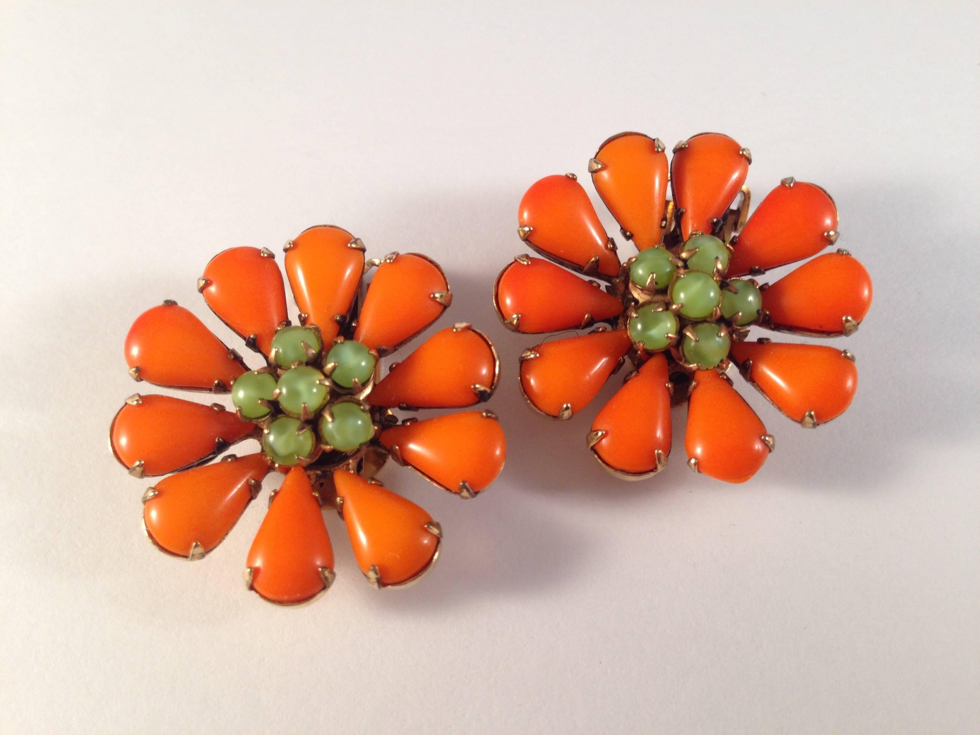 1960s flower clip-on earrings by Schreiner New York. Orange glass petals and green glass bead centers. These earrings are so fun and definitely make a statement. They measure 1 1/8