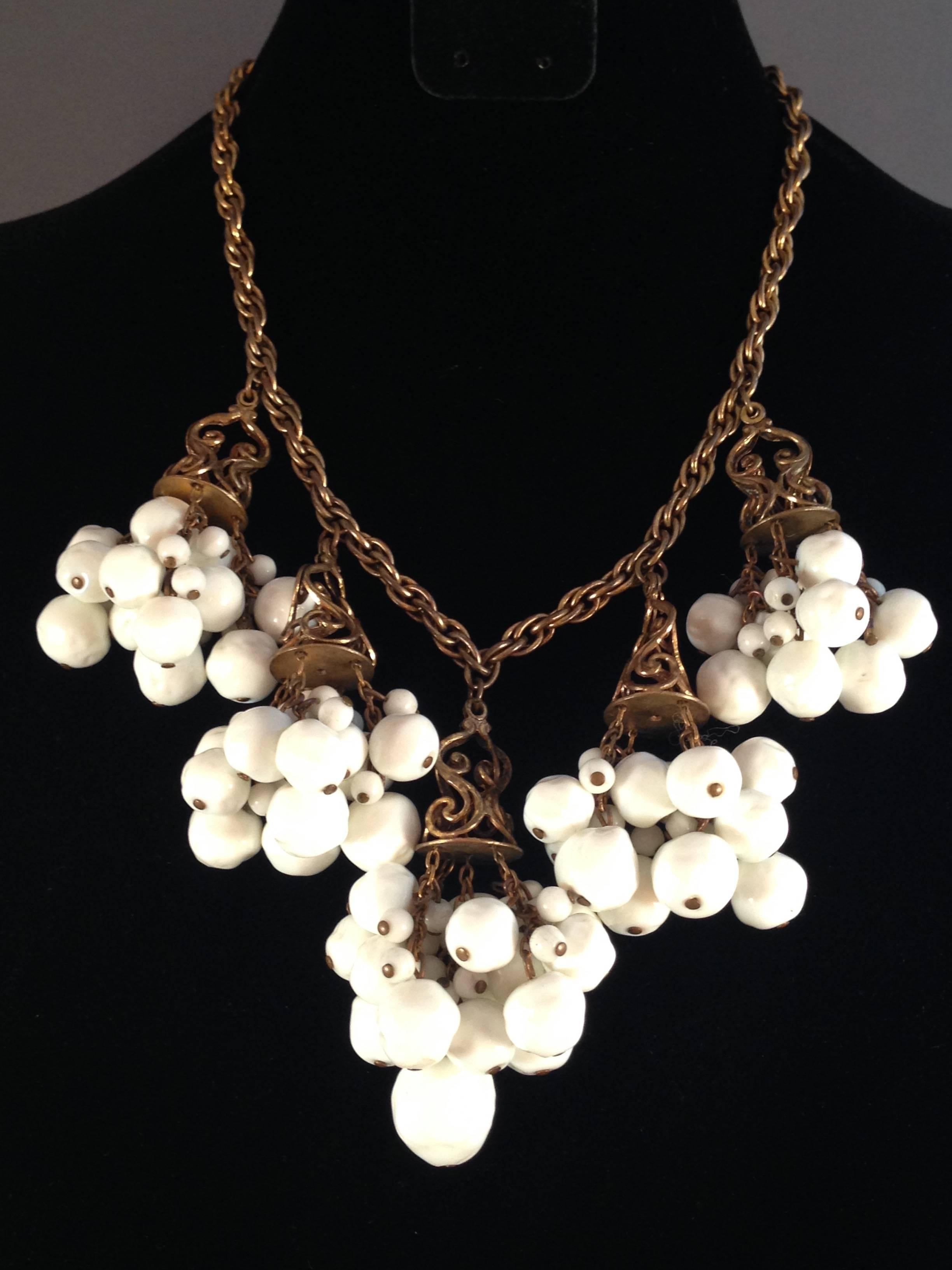 This is a 1940's white glass unsigned necklace designed by Frank Hess for Miriam Haskell. It is a signature Haskell piece. The early Haskell pieces were not signed. Pieces started to be signed in 1947. 

The necklace is made up of five white glass