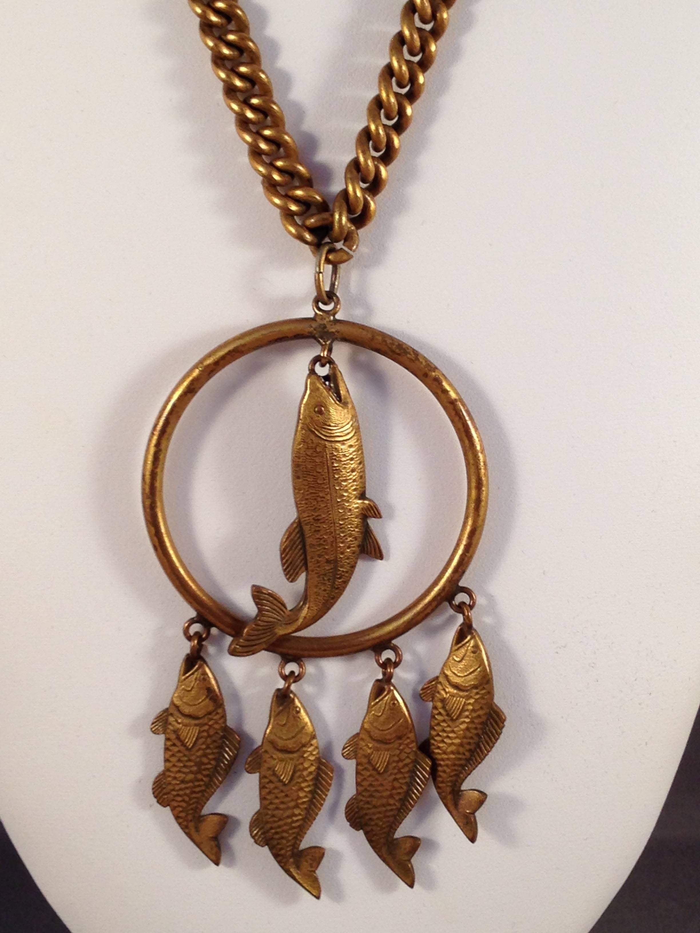 This is a 1940s Joseff of Hollywood necklace with a fish pendant. The necklace measures 24" long. The pendant with the bale is 4" long and 2" wide. It has a dark patina as is typical of the older Joseff of Hollywood pieces. It is