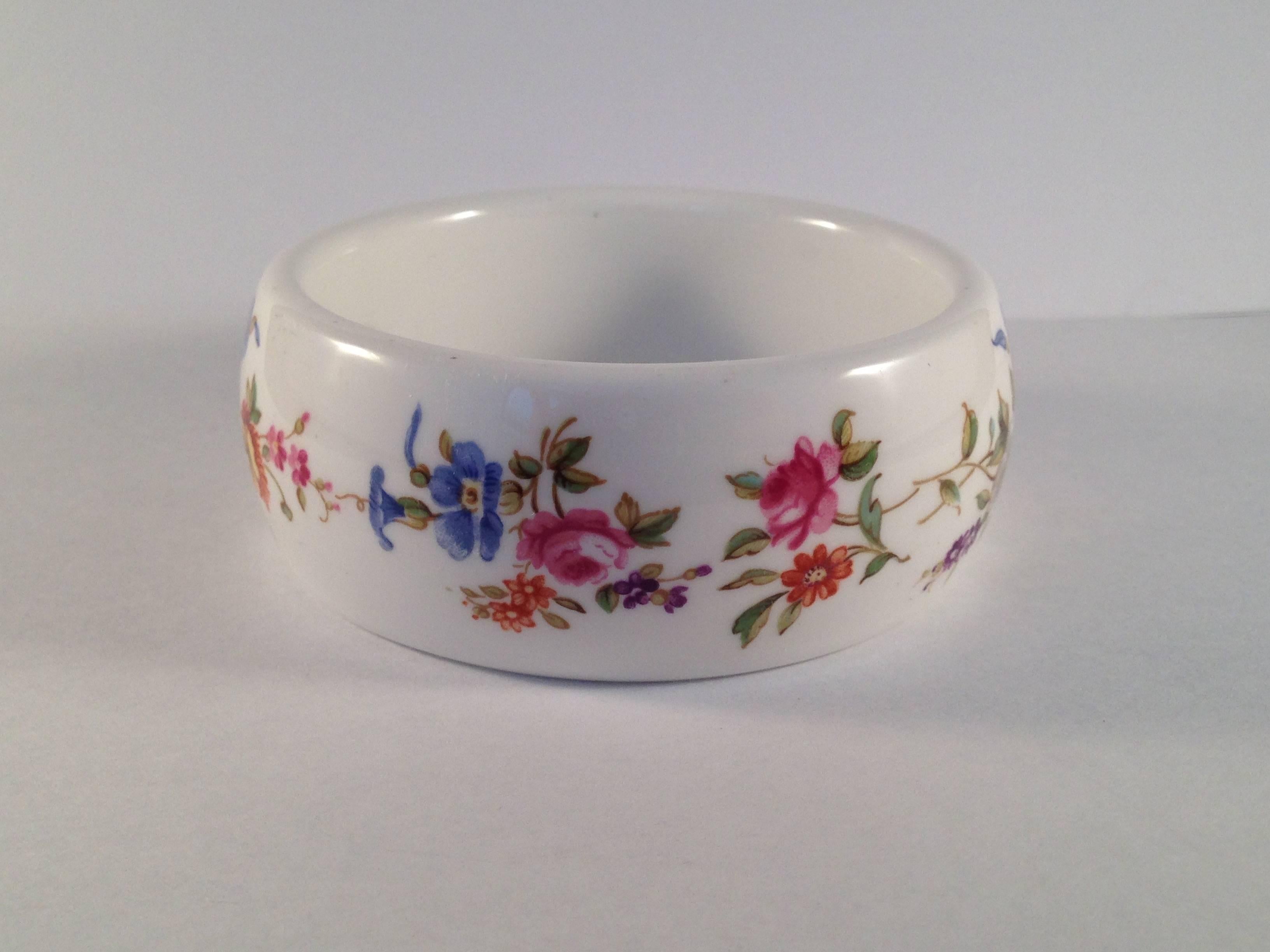 This is a bone china bracelet designed by Kenneth Jay Lane for the Royal Worcester Company. In 1976, Lane went to the Royal Worchester headquarters in England and chose several of their classic bone china patterns to fashion into necklaces and