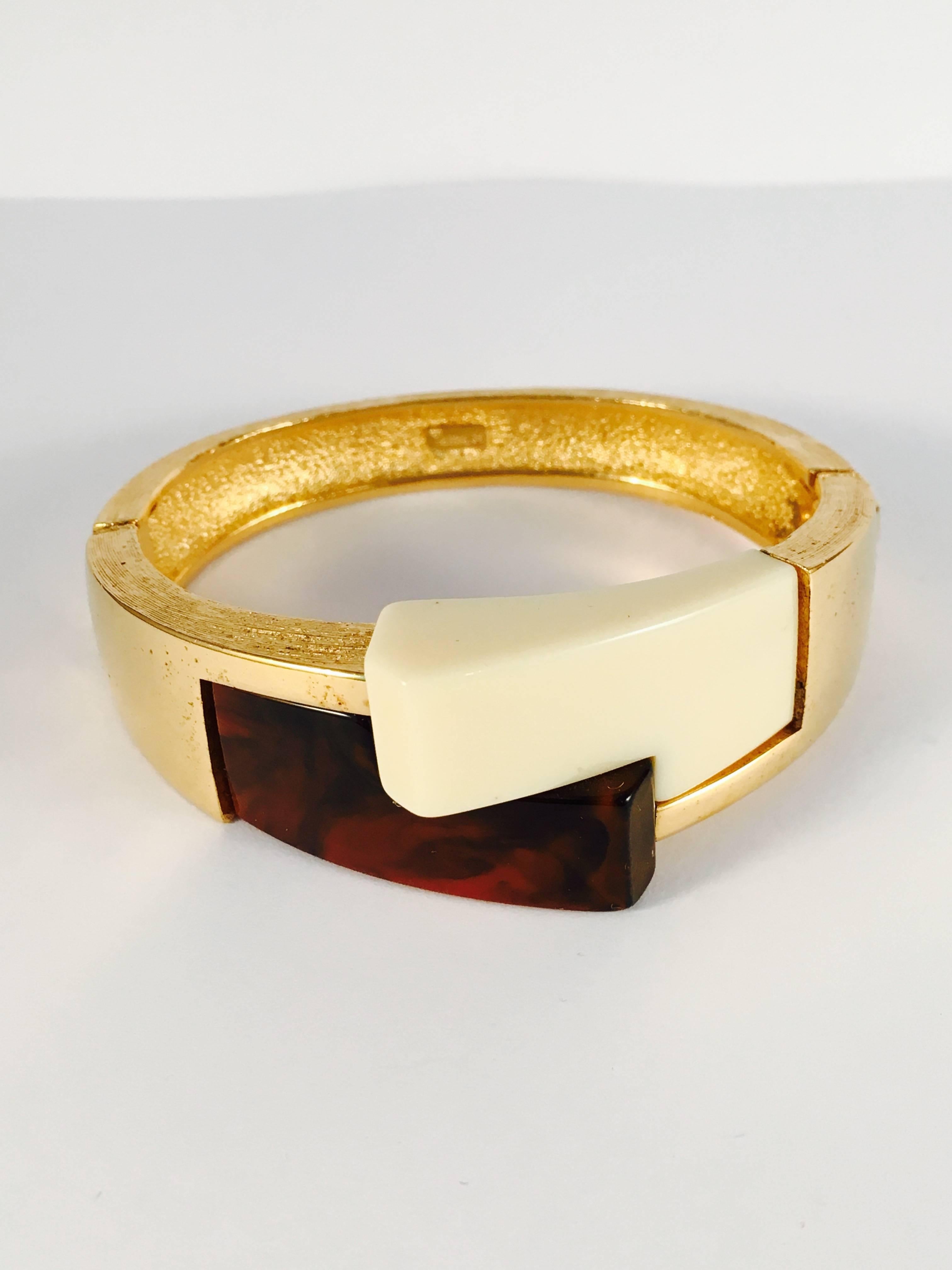 This is a 1970s Modernist bracelet by Trifari. It opens at the side and is made up of two resin modernist pieces at the front measuring 1
