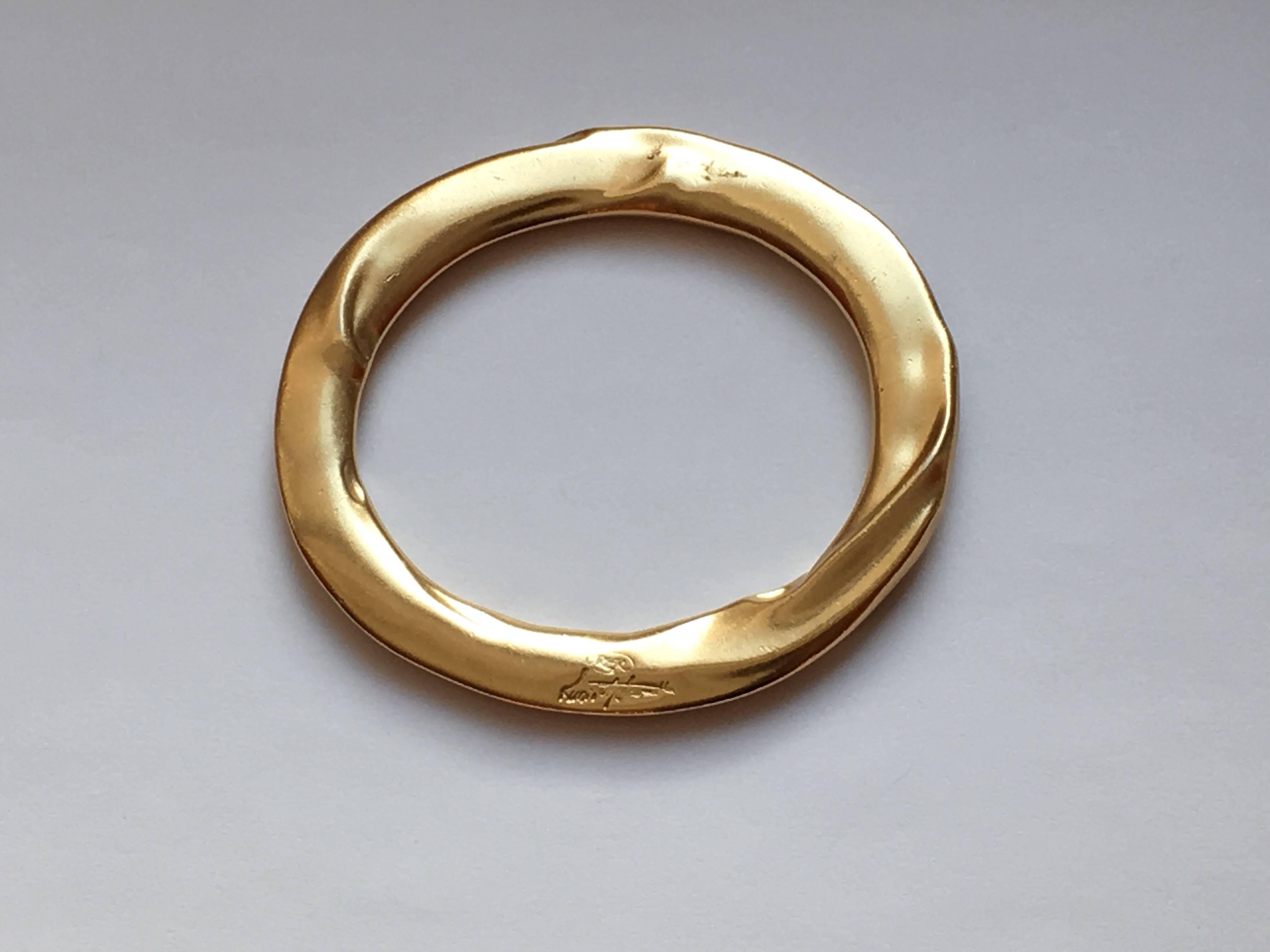 Goldtone Modernist bracelet designed by Kunio Matusmoto for Trifari. Matsumoto was a Japanese architect who designed jewelry for Trifari in the late 1970s. His pieces have a very sculptural quality to them. The bracelet's opening measures 2 1/2