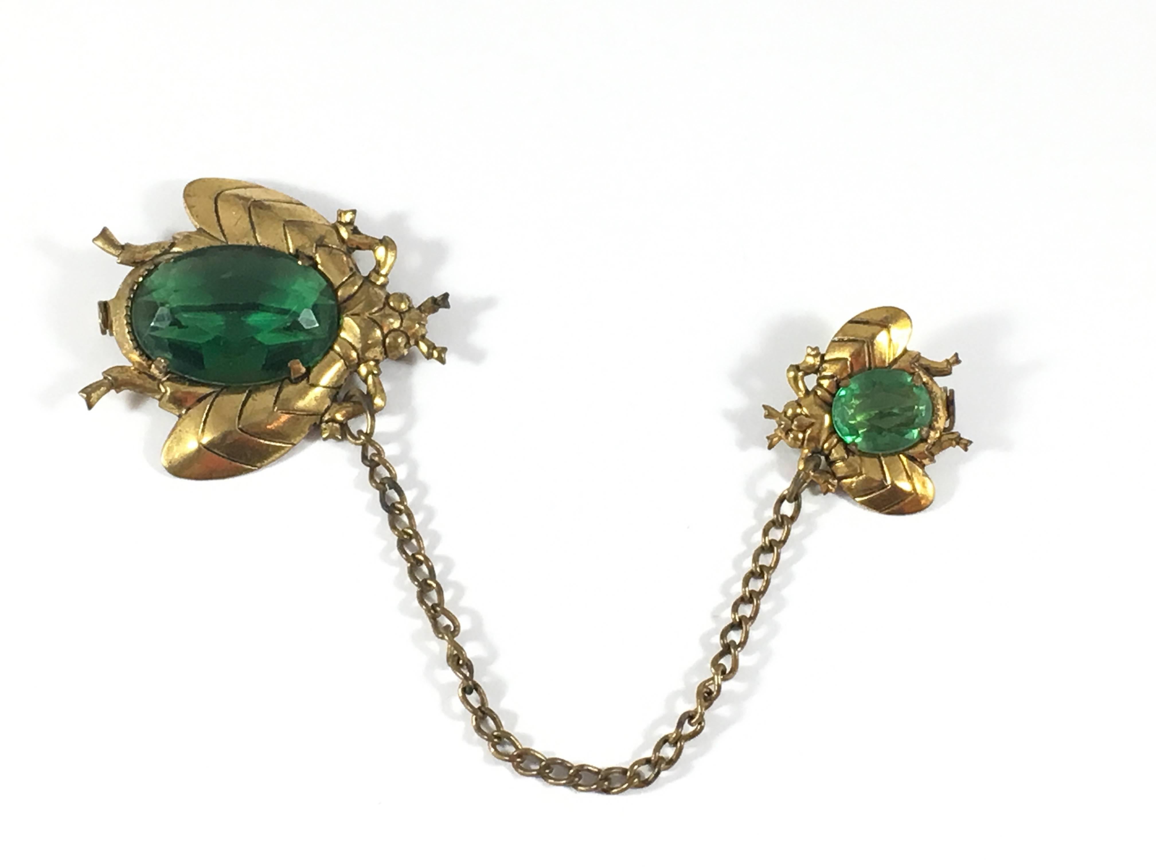 This is a super fun Art Deco Czech glass double bug brooch. The larger of the two bugs measures 1 3/4 inches high x 1 1/2 inches wide. The smaller bug measures 1 inches high x 1 inches wide. The chain that attaches the two bugs is 4 1/2 inches long.