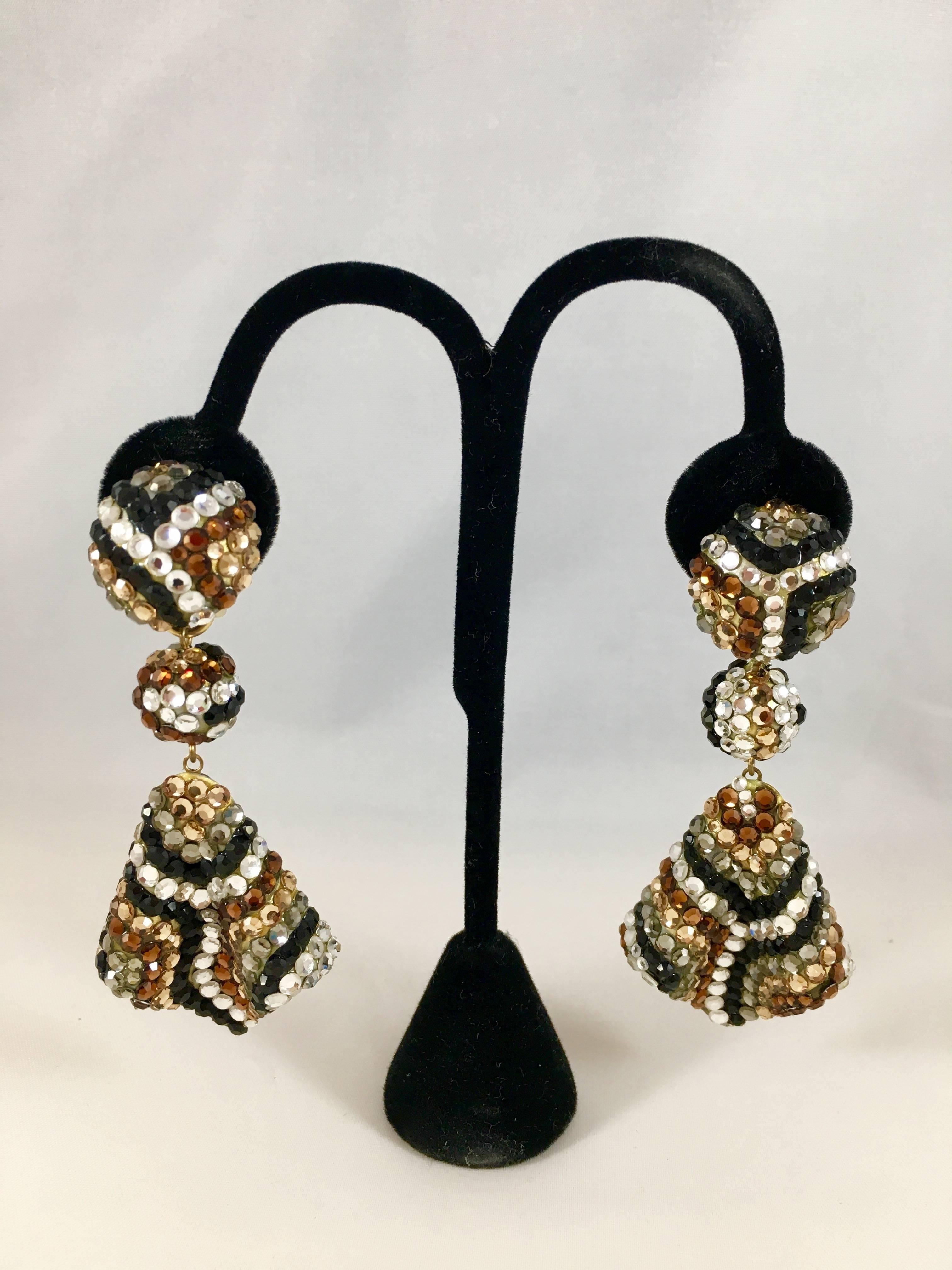 These cool statement earrings were made by Richard Kerr in the 1980s. They feature his signature all-over pave rhinestones in a pattern that evokes an animal print. They are signed 'Richard Kerr' in a plaque on the back of the earrings. The earrings
