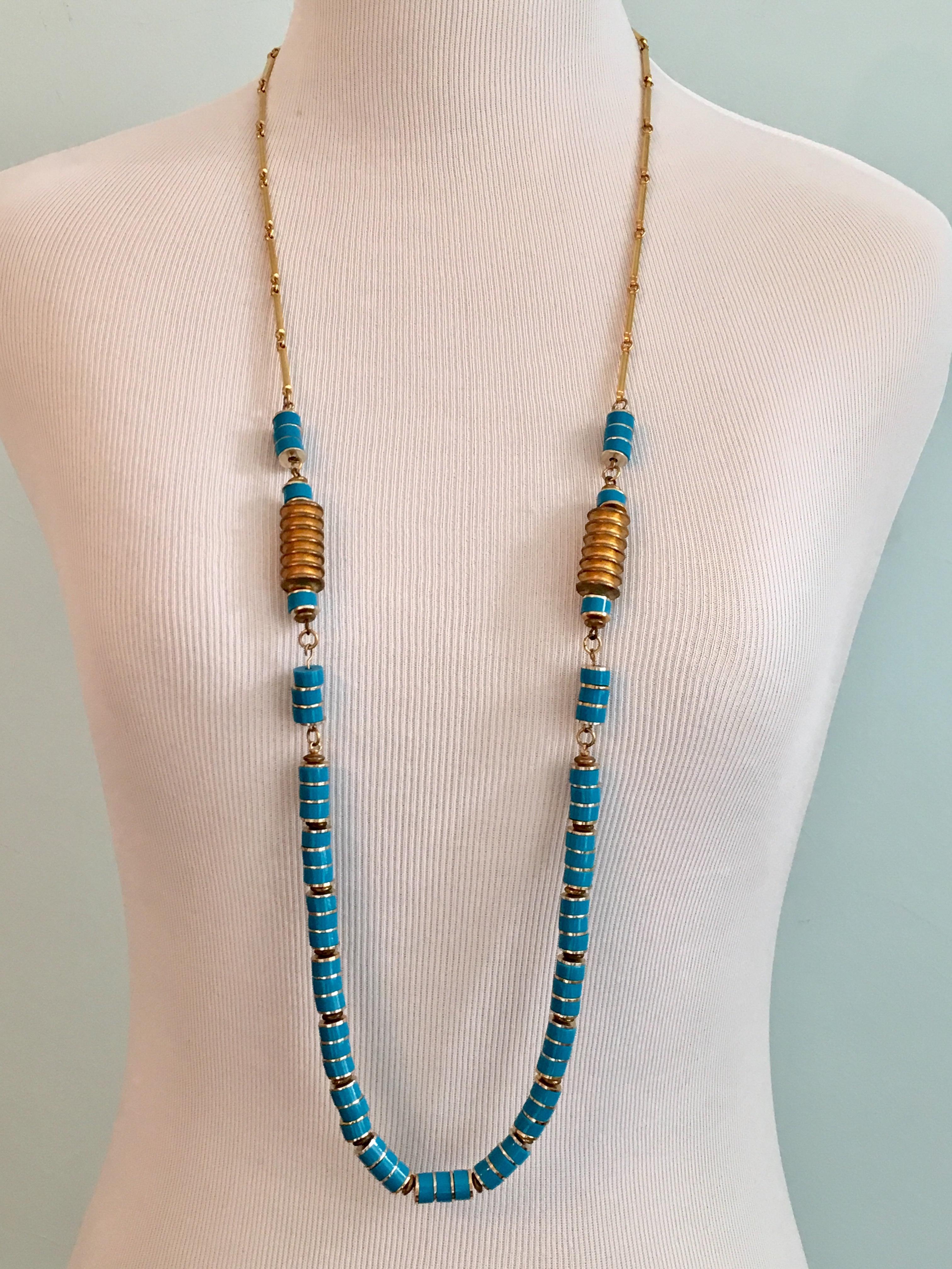 This is a 1970s Pierre Cardin gold tone necklace made up of turquoise colored resin beads. It is 38 inches long and fastens with an amazing Pierre Cardin logo clasp which can be worn at the back or to the side. Truly a stunning piece which can be