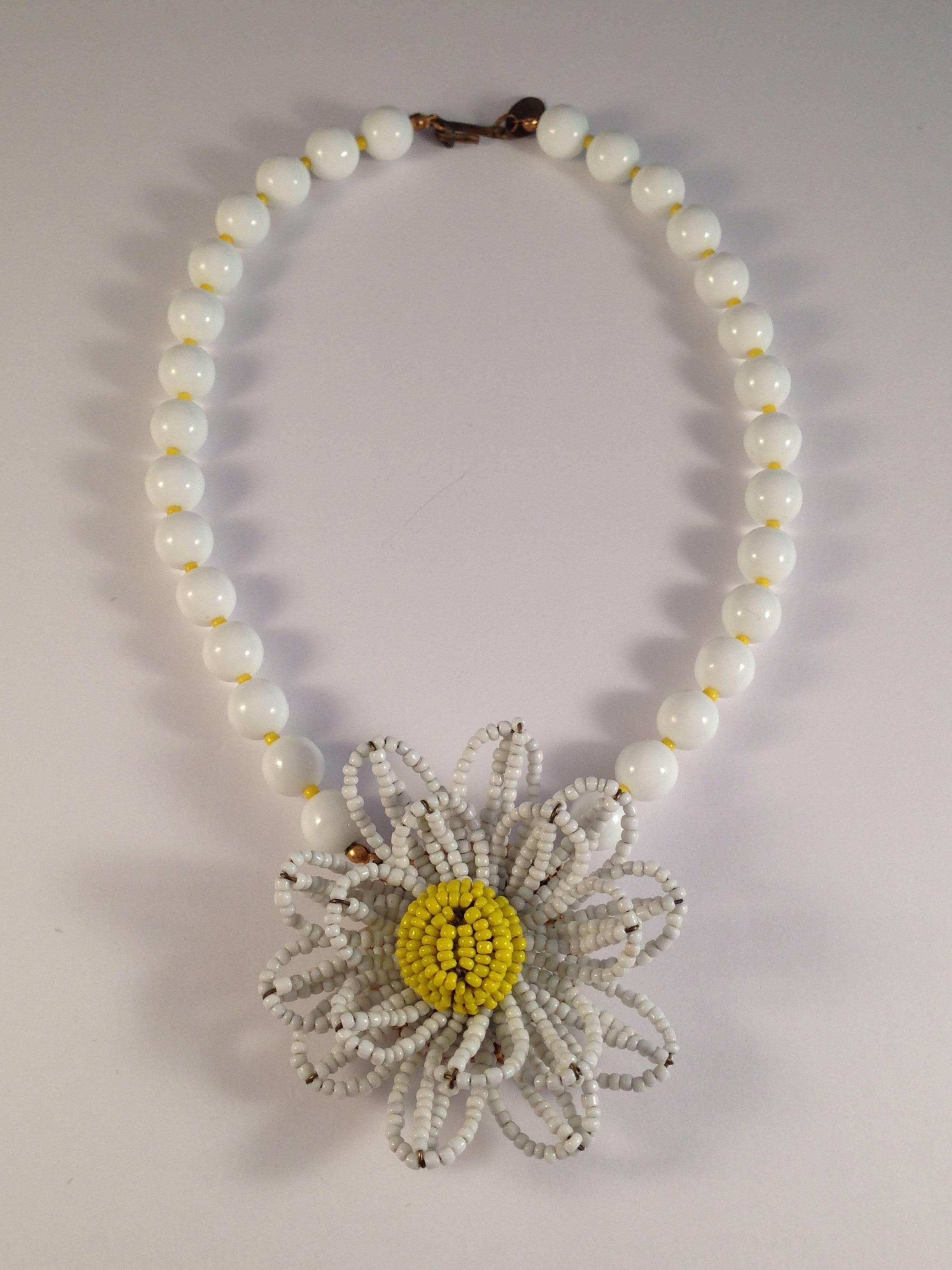 This is so fun for Spring. It is a 1950s Miriam Haskell necklace with a beaded daisy pendant. The pendant measures approximately 2 1/2" in diameter and is made up of tiny glass seed beads. The necklace measures 15" (not including the