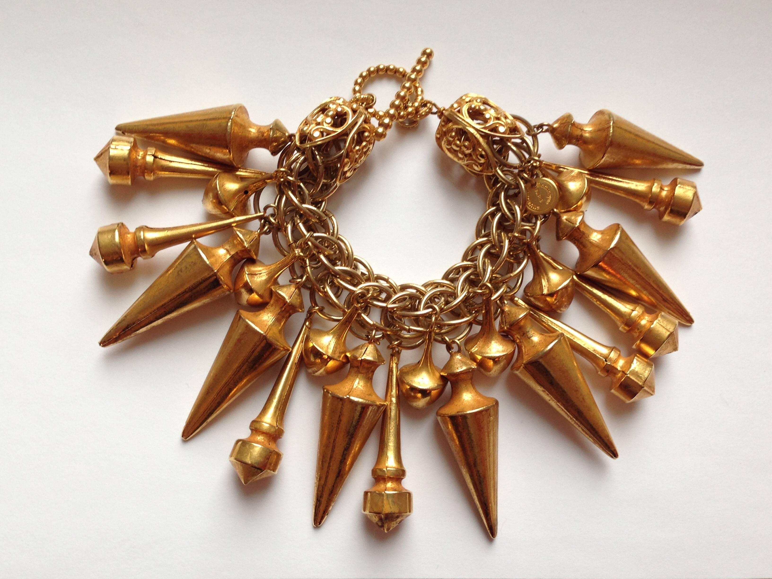 This is a large statement making 1980s goldtone Dominique Aurientis bracelet with hanging charms. The chain is 7 1/2