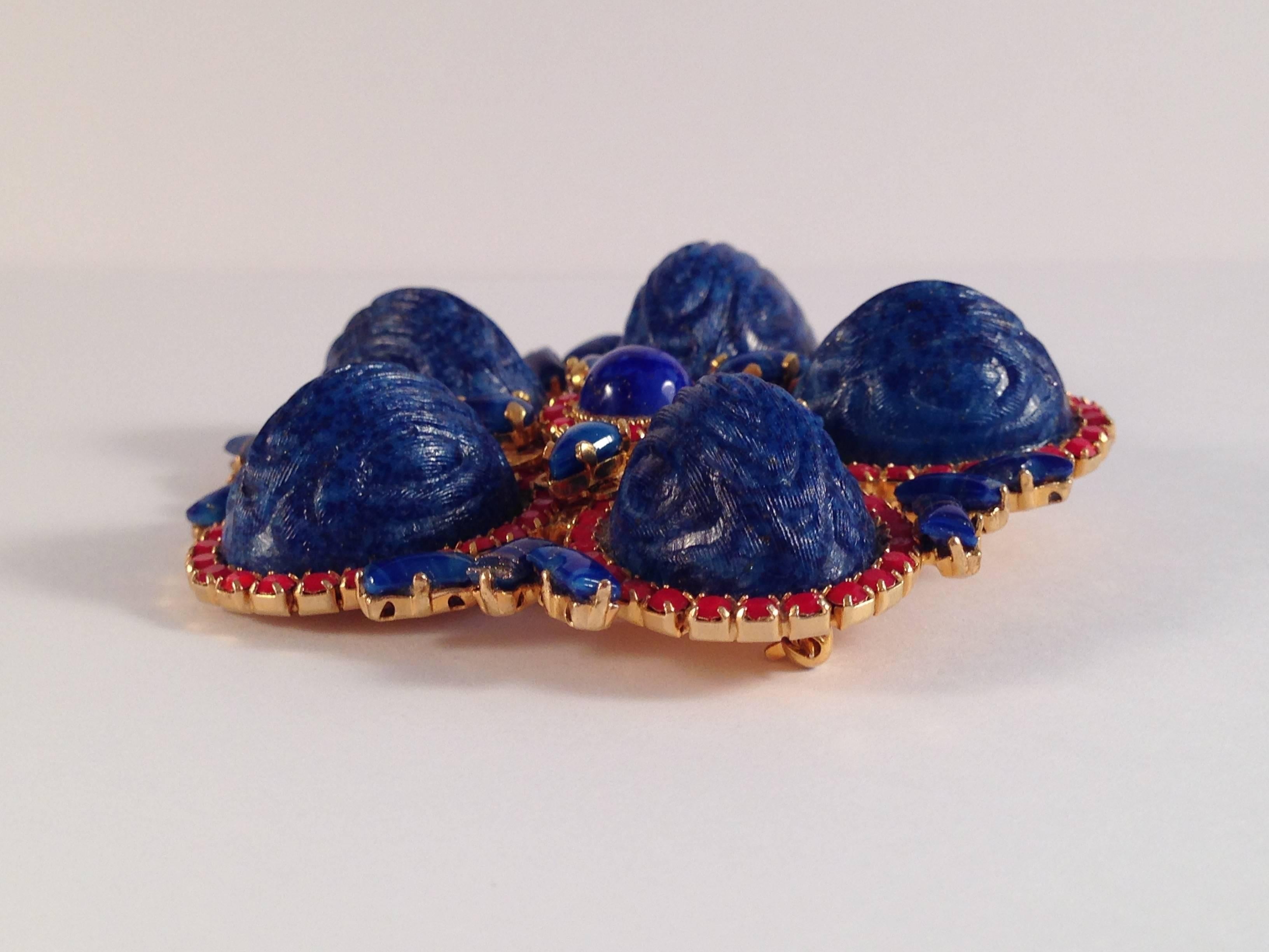 This is a rare and beautiful blue and red glass brooch designed by William de Lillo in 1971. It comes from the William de Lillo archives of samples and prototypes. This brooch is part of a set that include a matching necklace and earrings which I