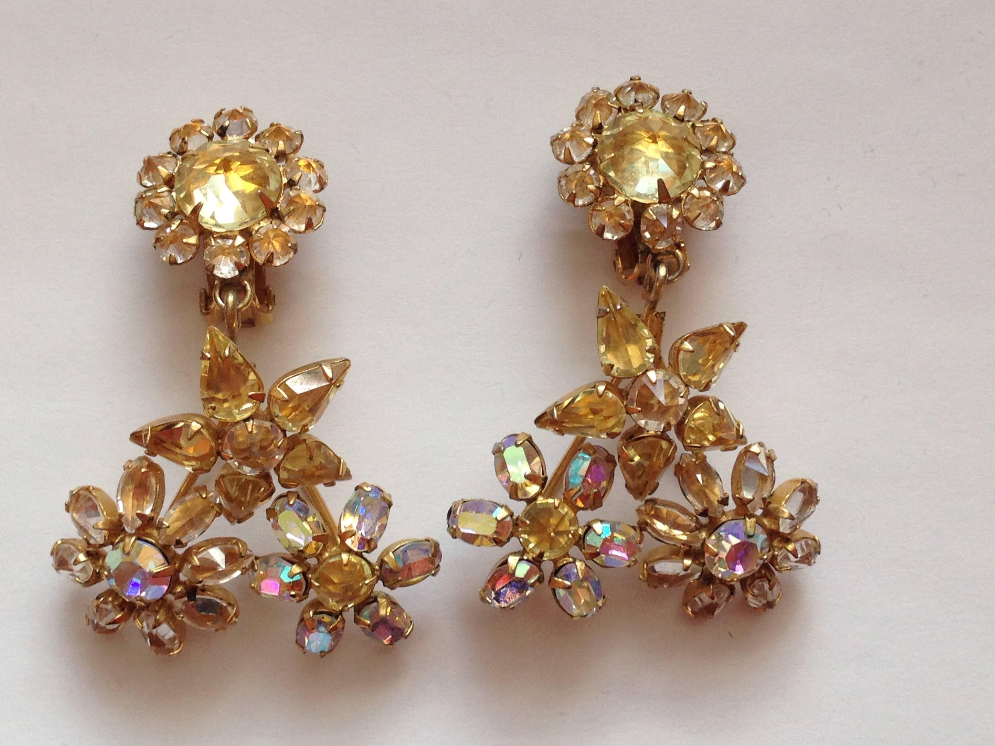 This is a beautiful pair of 1950s Schreiner clip-on earrings. They are gold toned metal set with yellow and clear aurora borealis glass crystals set with the pointed side up - a Schreiner trademark.  They measure 2 1/2" long x 5/8" wide