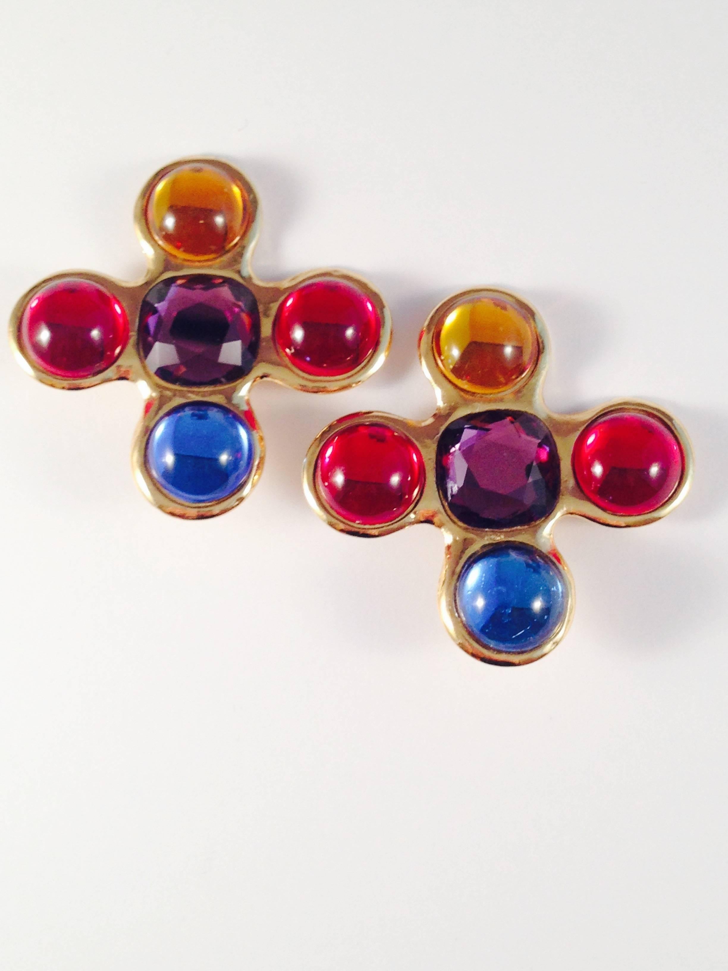 This is a fabulous pair of 1980s Yves Saint Laurent maltese cross clip-on earrings. They are gold tone with multi-colored glass and cabochon stones. They measure 2