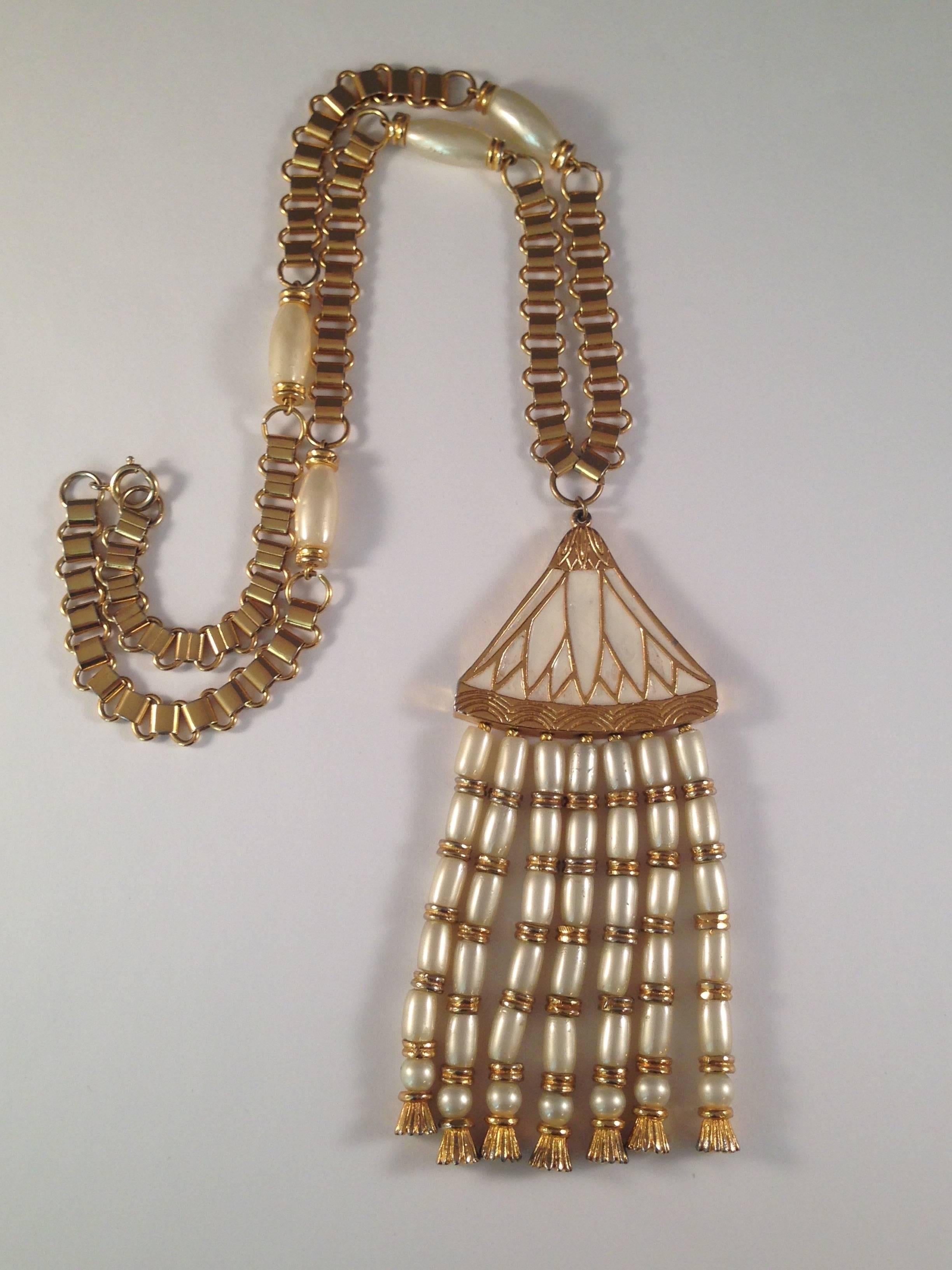 This is a 1960s Miriam Haskell Egyptian Revival gold tone book chain necklace with a lotus pendant. The chain measures 22