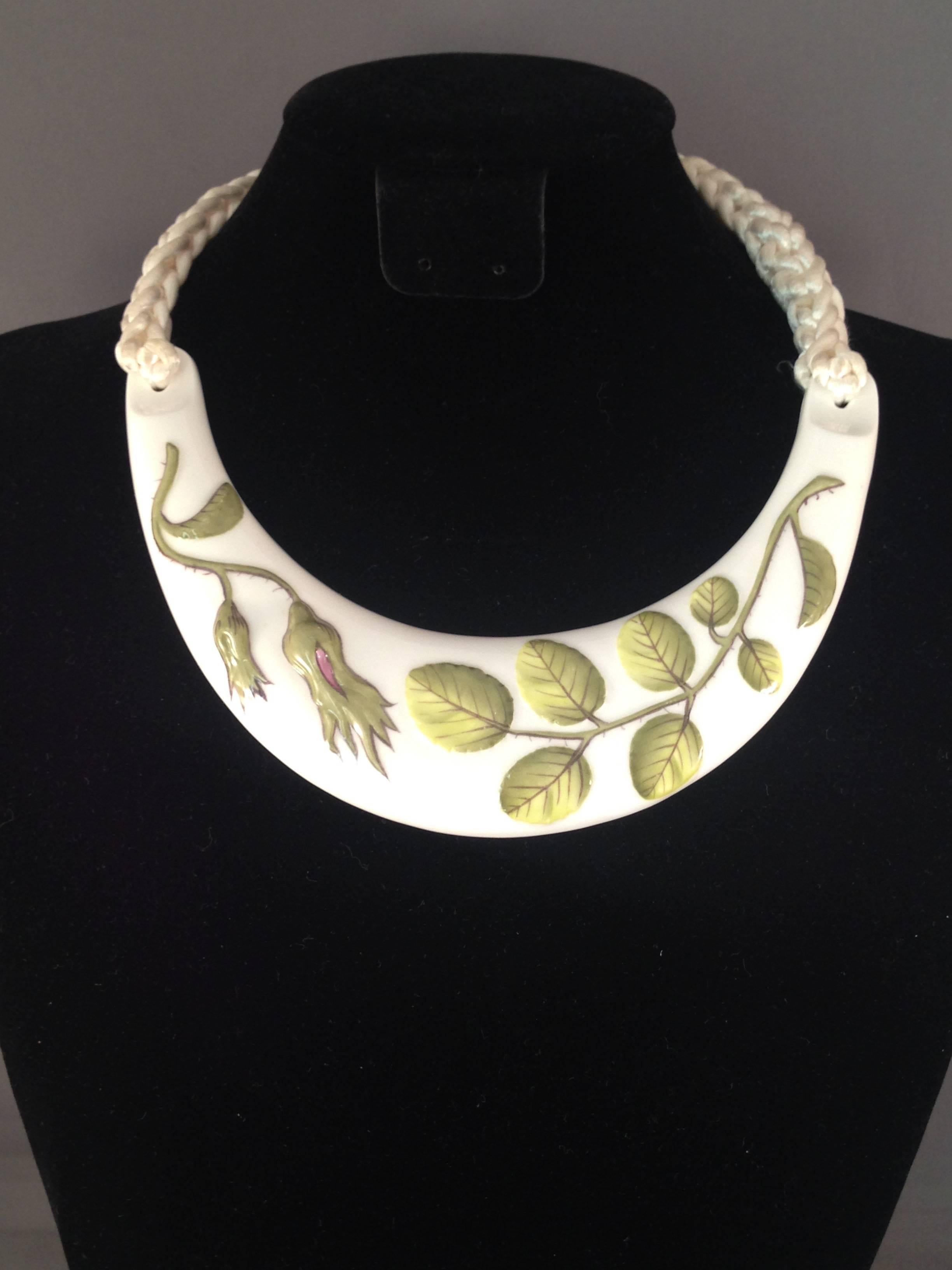 This is a rare bone china necklace designed by Kenneth Jay Lane for the Royal Worchester Company in 1976. Lane went to the Royal Worchester headquarters in England and chose several of their classic bone china patterns to fashion into collar