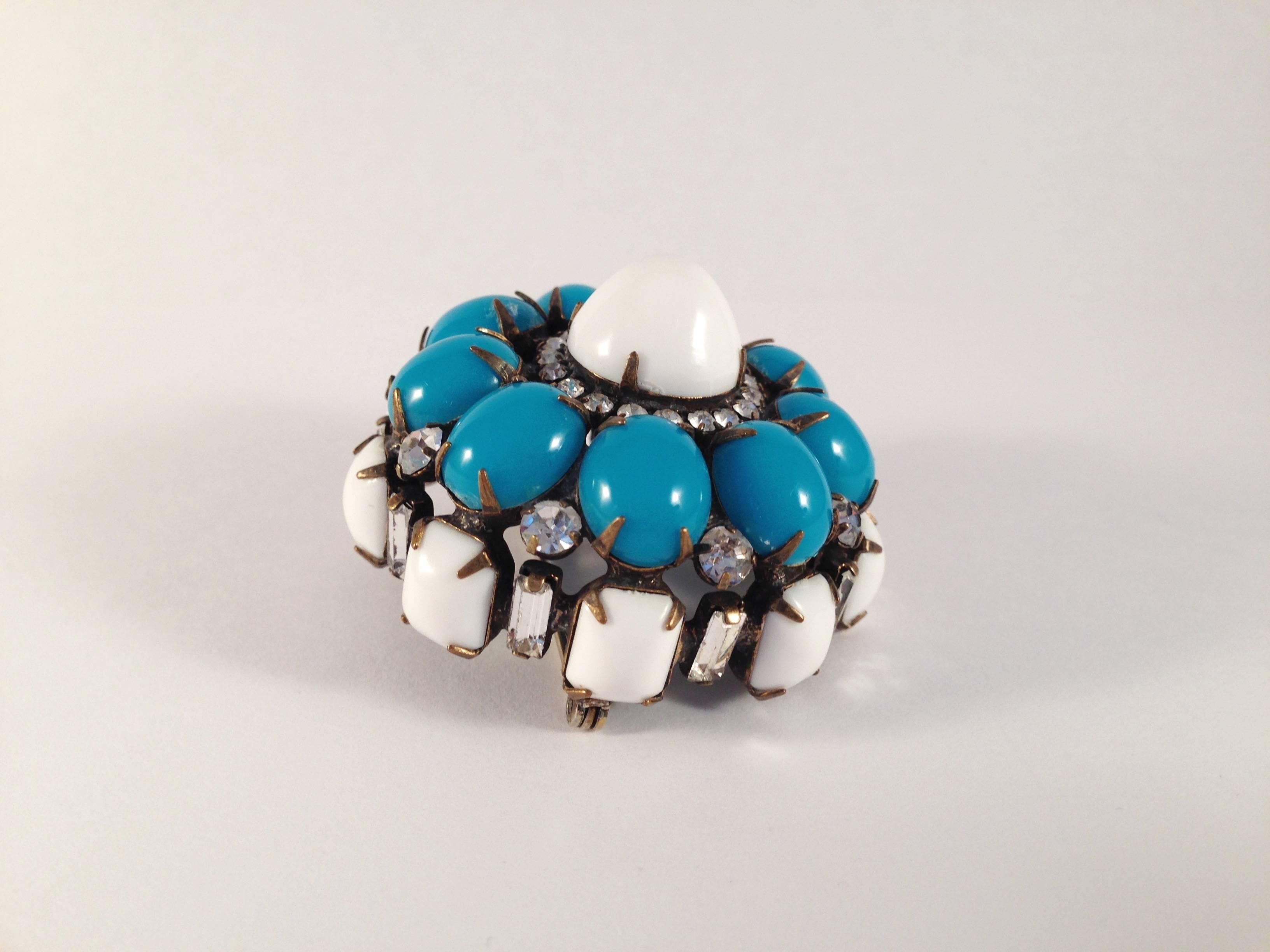 This is a fabulous 3-dimensional 1960s Kenneth Jay Lane brooch. It is made out of blue and white glass and resin stones and clear rhinestones. It measure 1 7/8