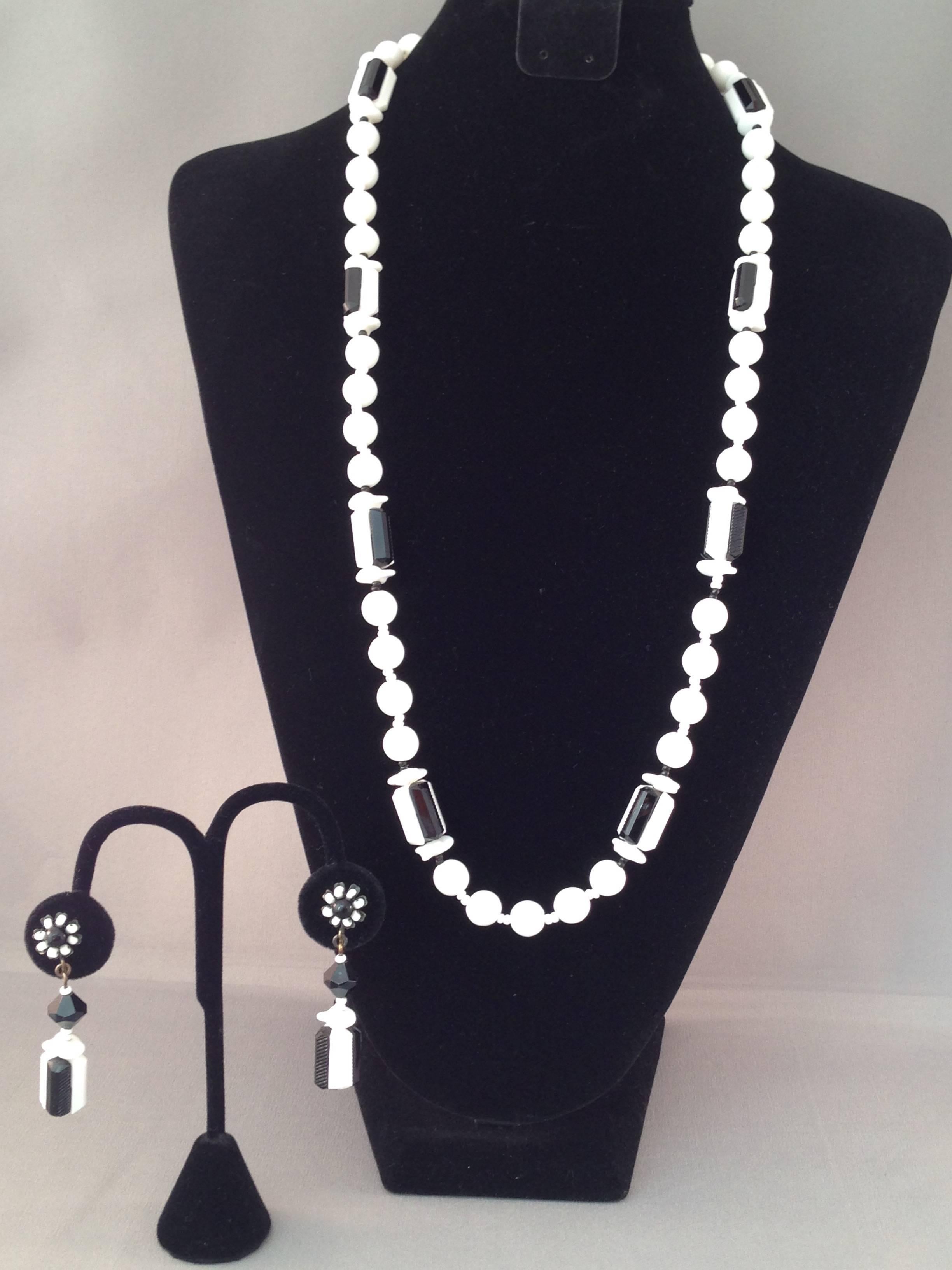 1960s Miriam Haskell black and white glass bead necklace and earring set. The necklace is 29" long and is marked "Miriam Haskell" on the back of the clasp. The clip-on earrings measure 2 1/4" long and are marked "Miriam