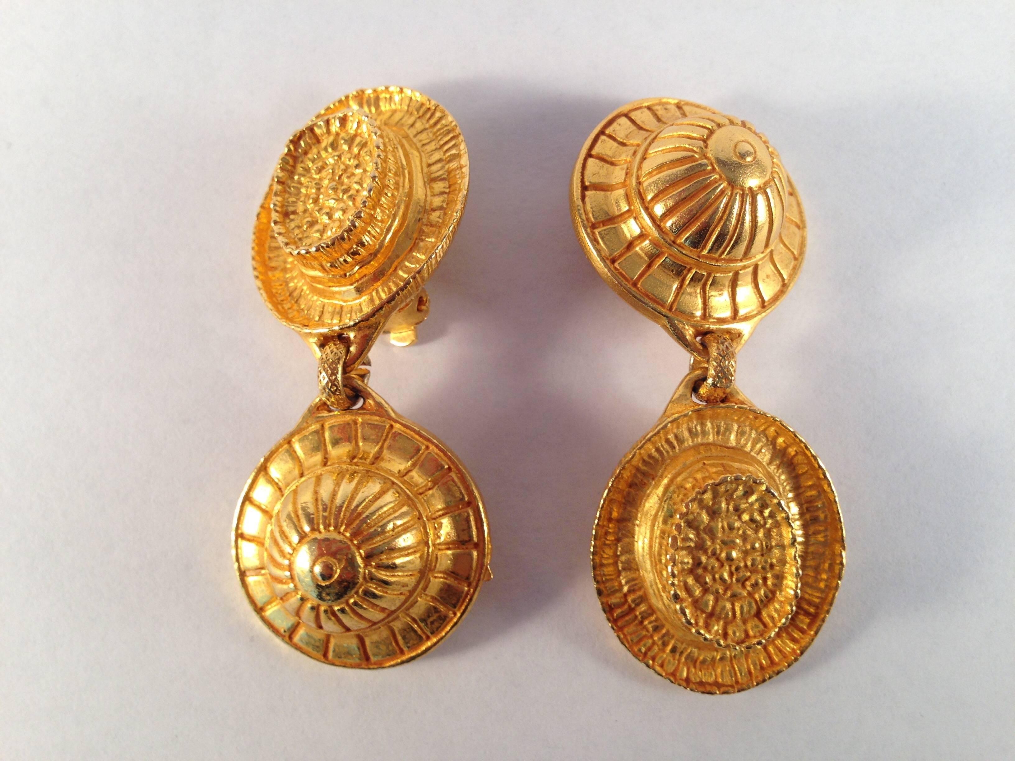 These are vintage Dominique Aurientis earrings featuring two different hats. They measures almost 2 1/2" long x 1" wide. They are marked 'Dominique Aurientis Paris' on a round metal tag on the back (see photo #4). They date from the 1980s