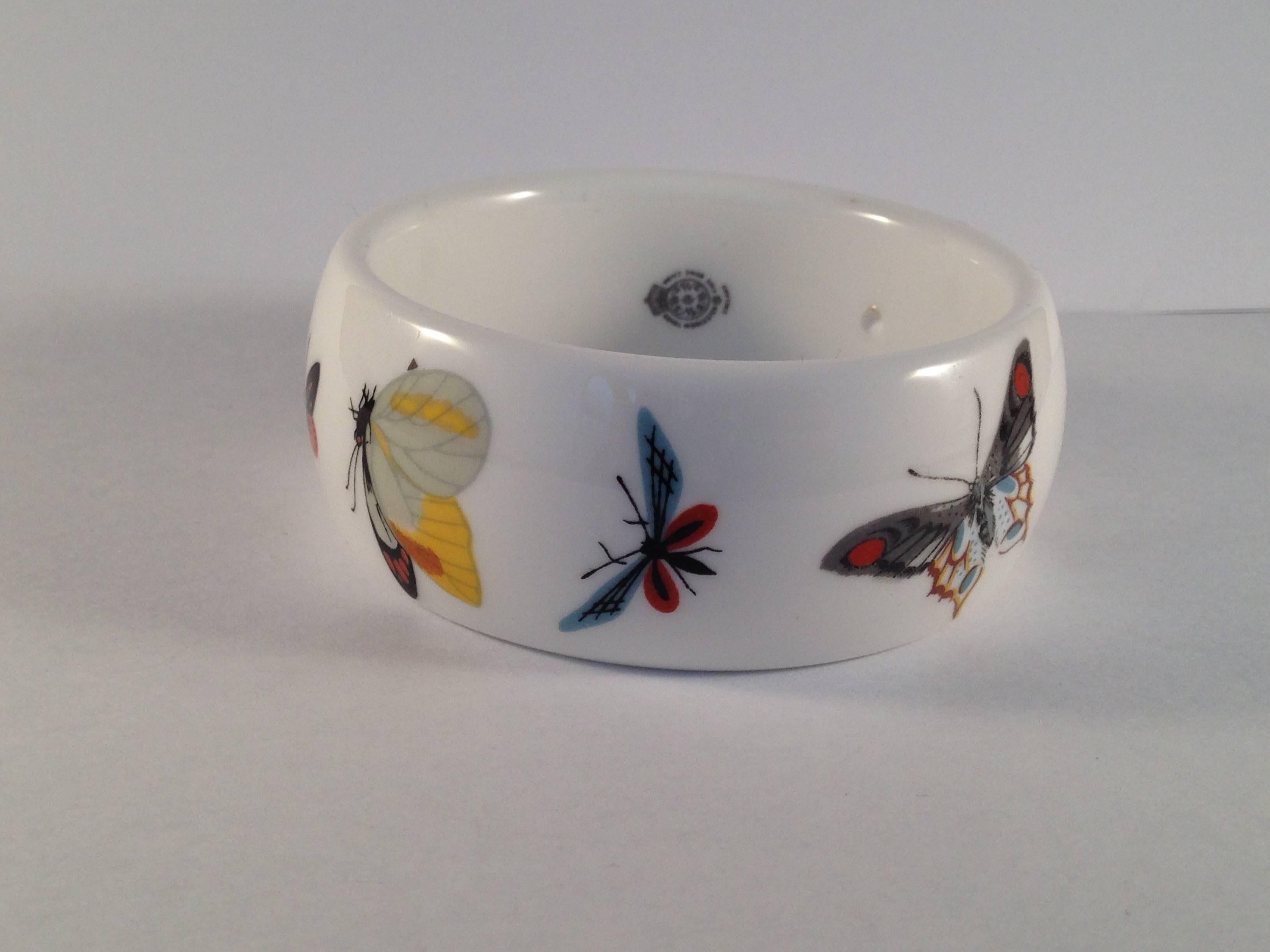 This is a bone china bracelet designed by Kenneth Jay Lane for the Royal Worchester Company. In 1976, Lane went to the Royal Worchester headquarters in England and chose several of their classic bone china patterns to fashion into necklaces and