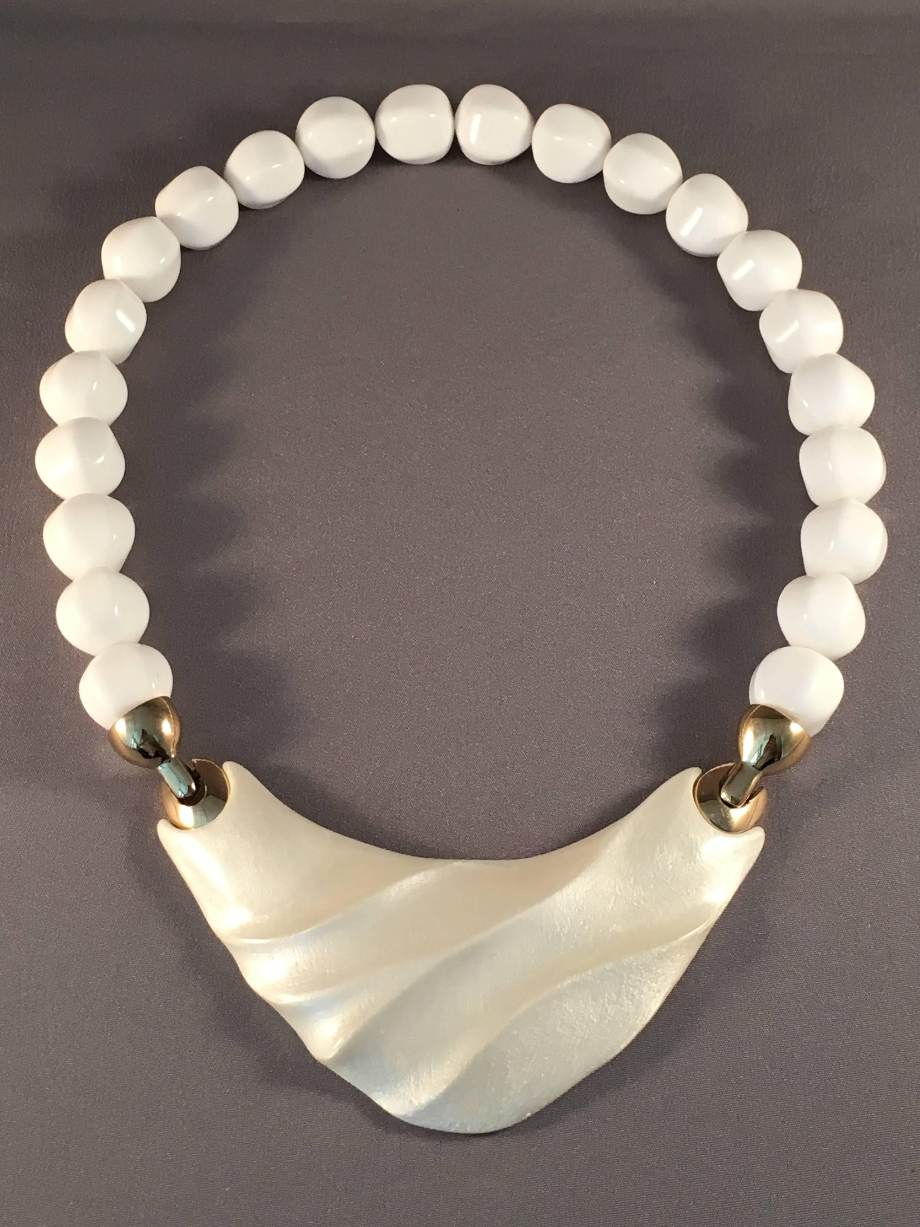 White Modernist necklace designed by Kunio Matusmoto for Trifari. Matsumoto was a Japanese architect who designed jewelry for Trifari in the late 1970s. His pieces have a very sculptural quality to them. The necklace measures 18". It is made of
