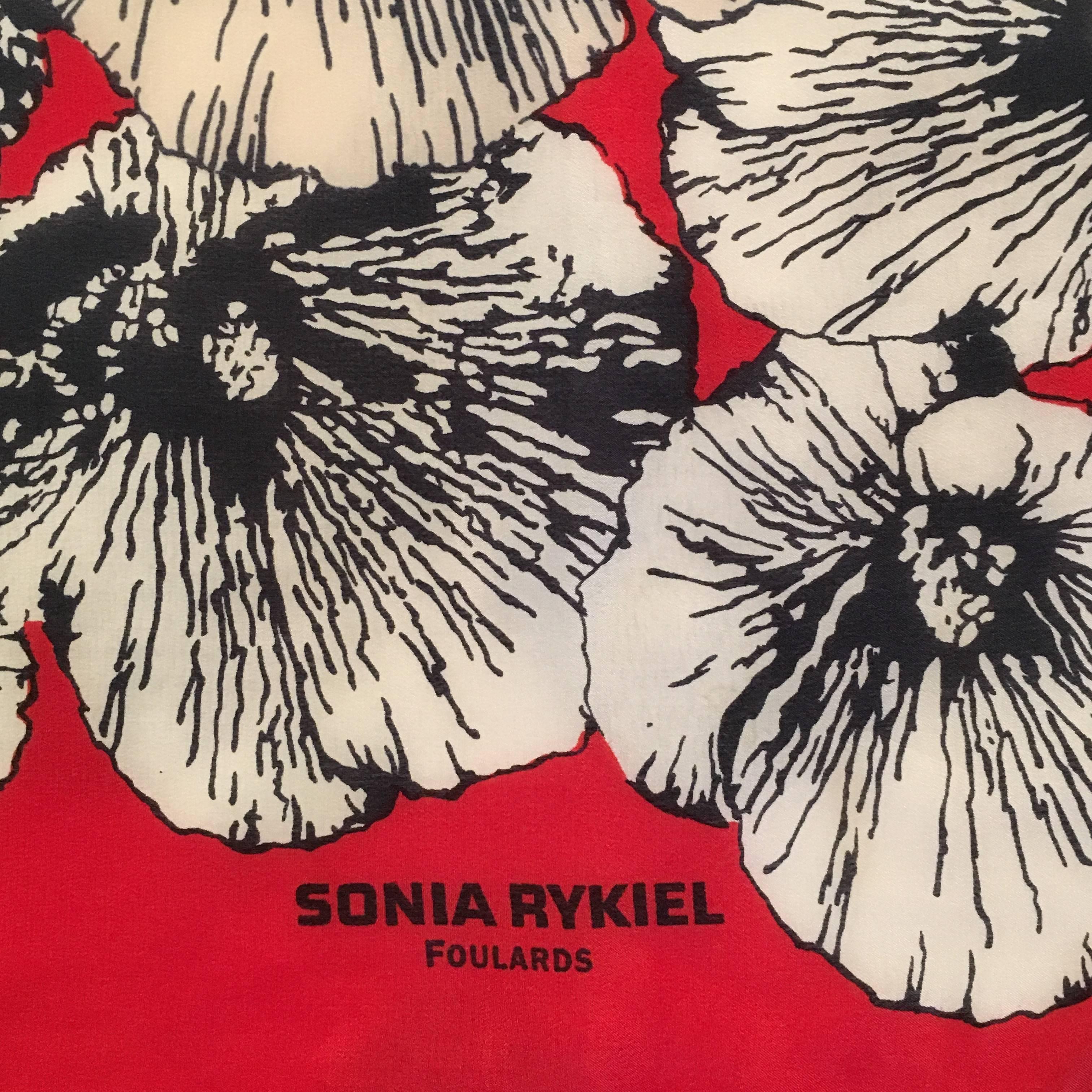 This is a large red Sonia Rykiel scarf with printed black and white poppy flowers. It measures 44 3/4